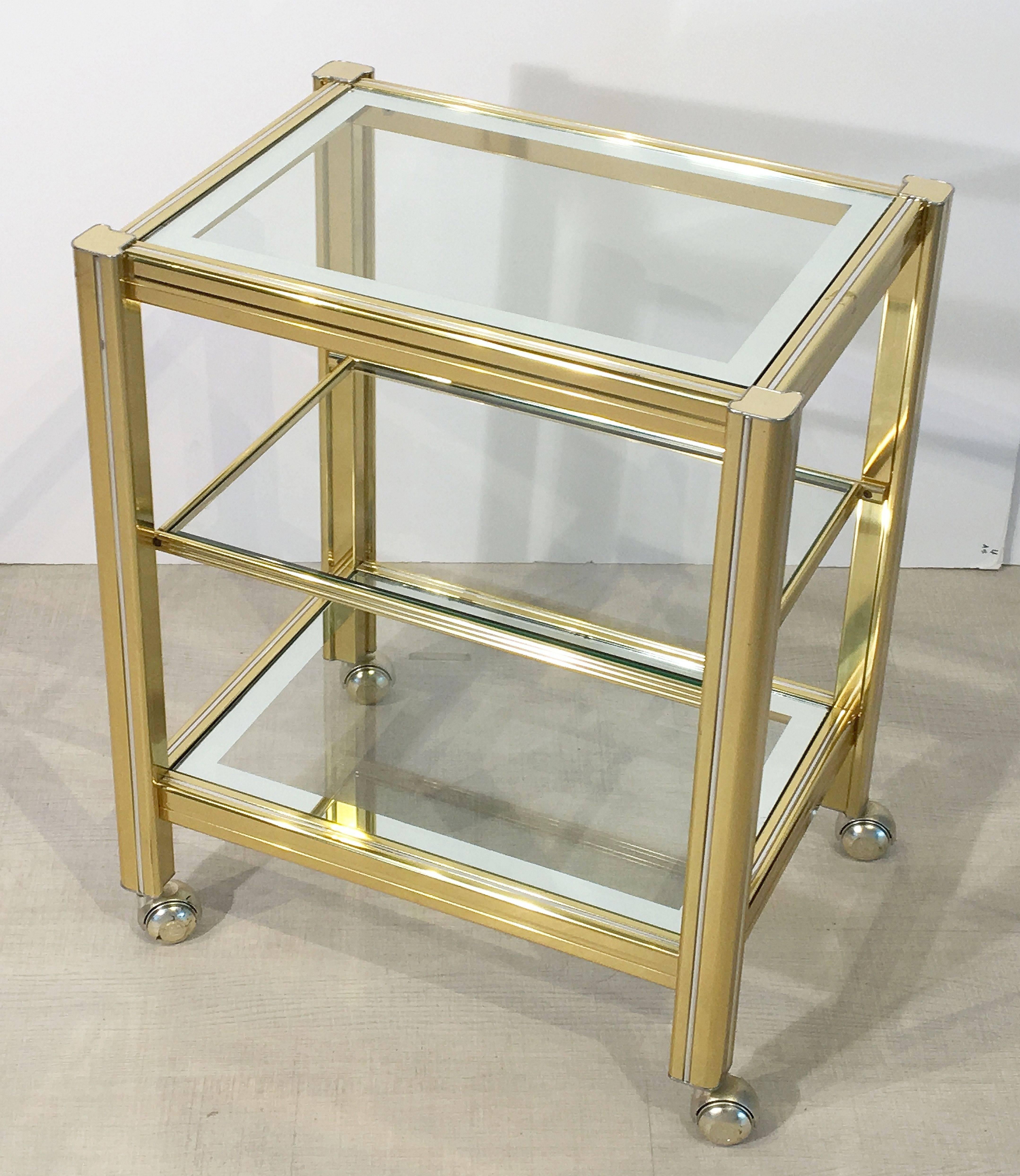 A fine Italian drinks trolley or bar cart, featuring three tiers of rectangular glass set into a stylish brass and chrome frame on rolling casters.

Makes a great side or occasional table.