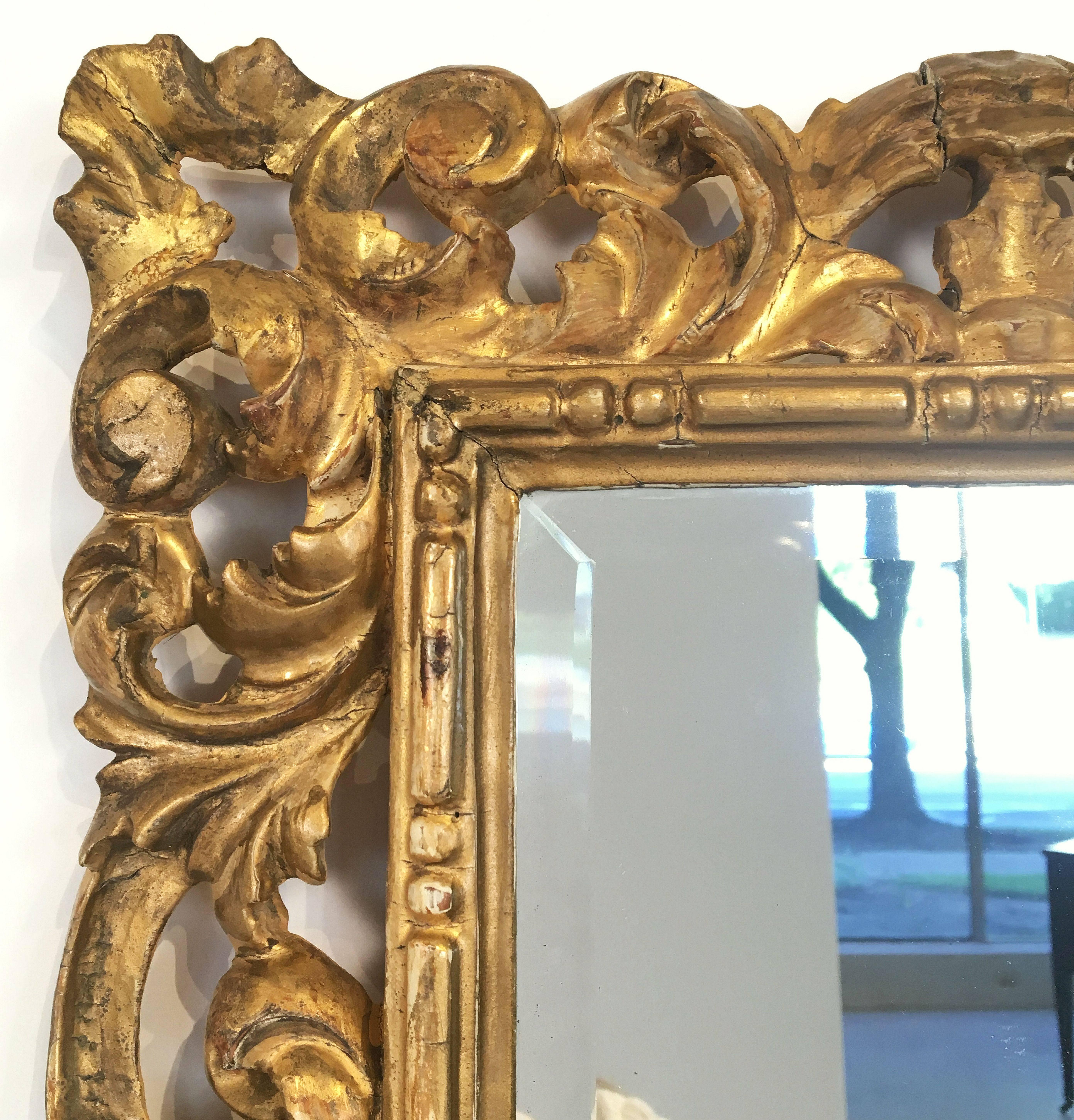 A fine Rococo rectangular beveled mirror with a carved giltwood frame.

Dimensions are H 22 1/2 inches x W 16 1/2 inches