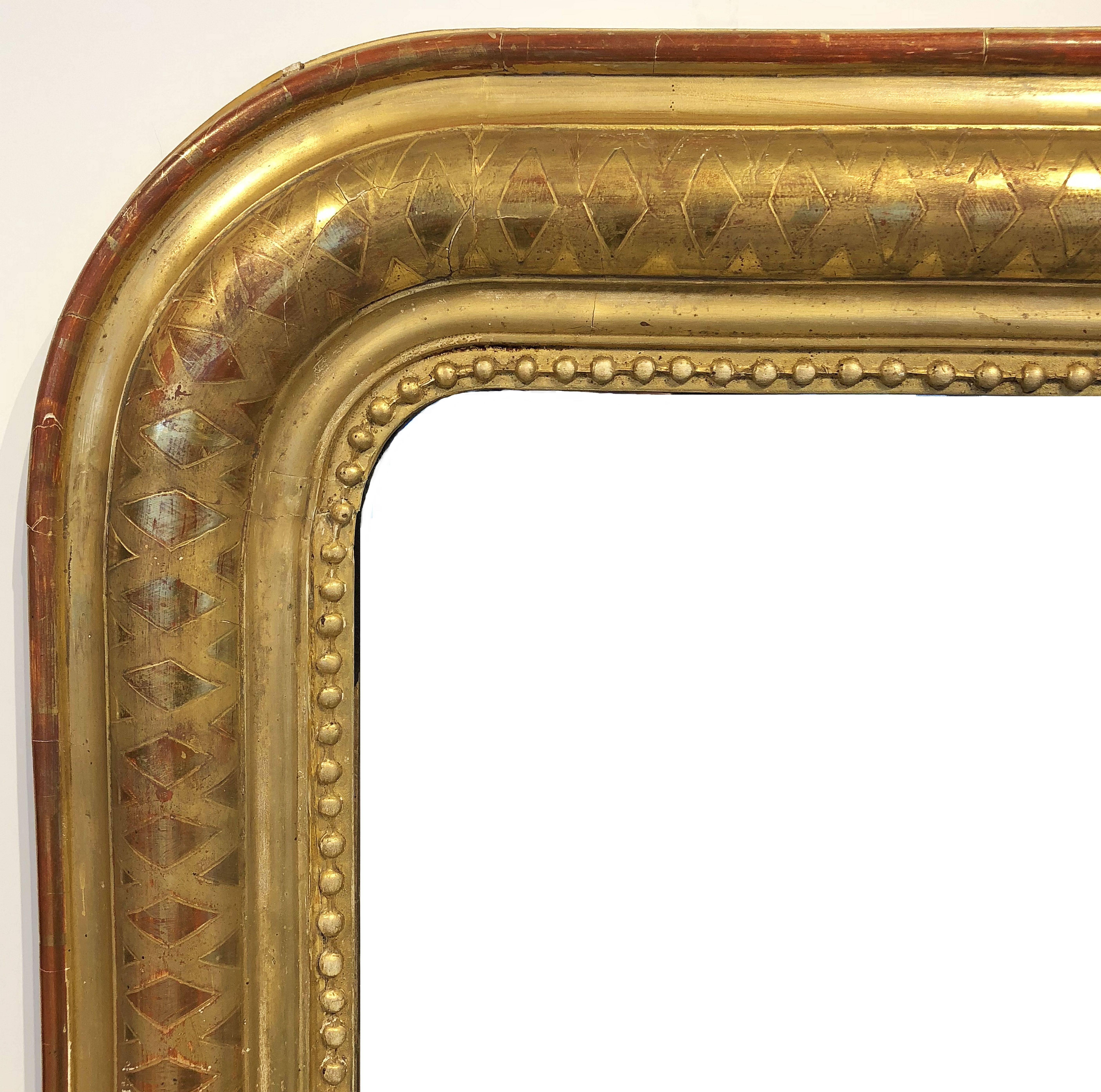 A fine Louis Philippe wall mirror featuring a moulded surround with a beautiful patinated gold-leaf.

Dimensions: H 56 inches x W 35 inches

Other sizes available in this style.