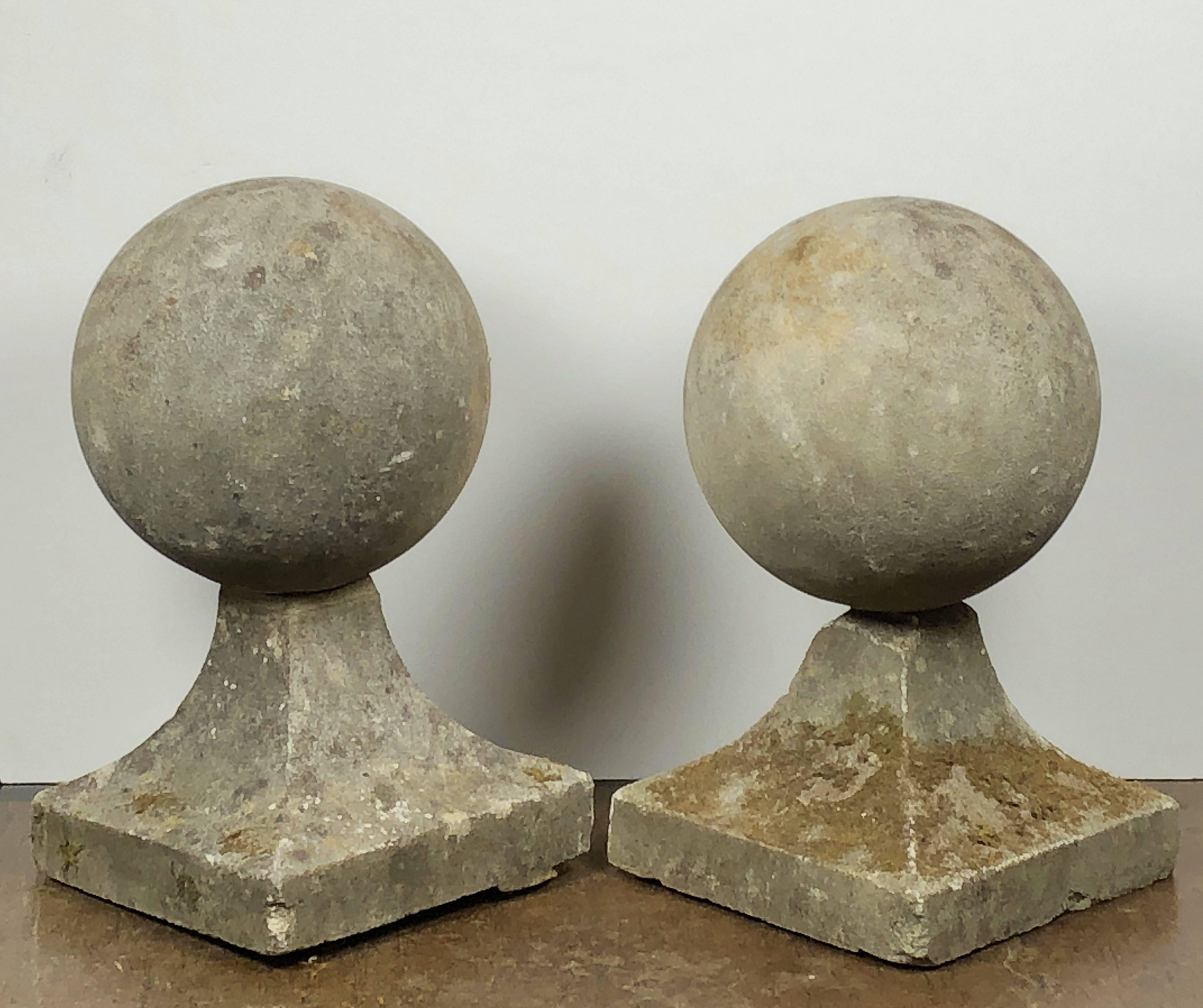 A fine pair of English coping balls of composition stone, each ball set upon a square plinth base.

Dimensions are H 23 inches x D 13 inches

Perfect for use as an indoor or outdoor garden, garden room, or patio feature!

Individually priced - $2495
