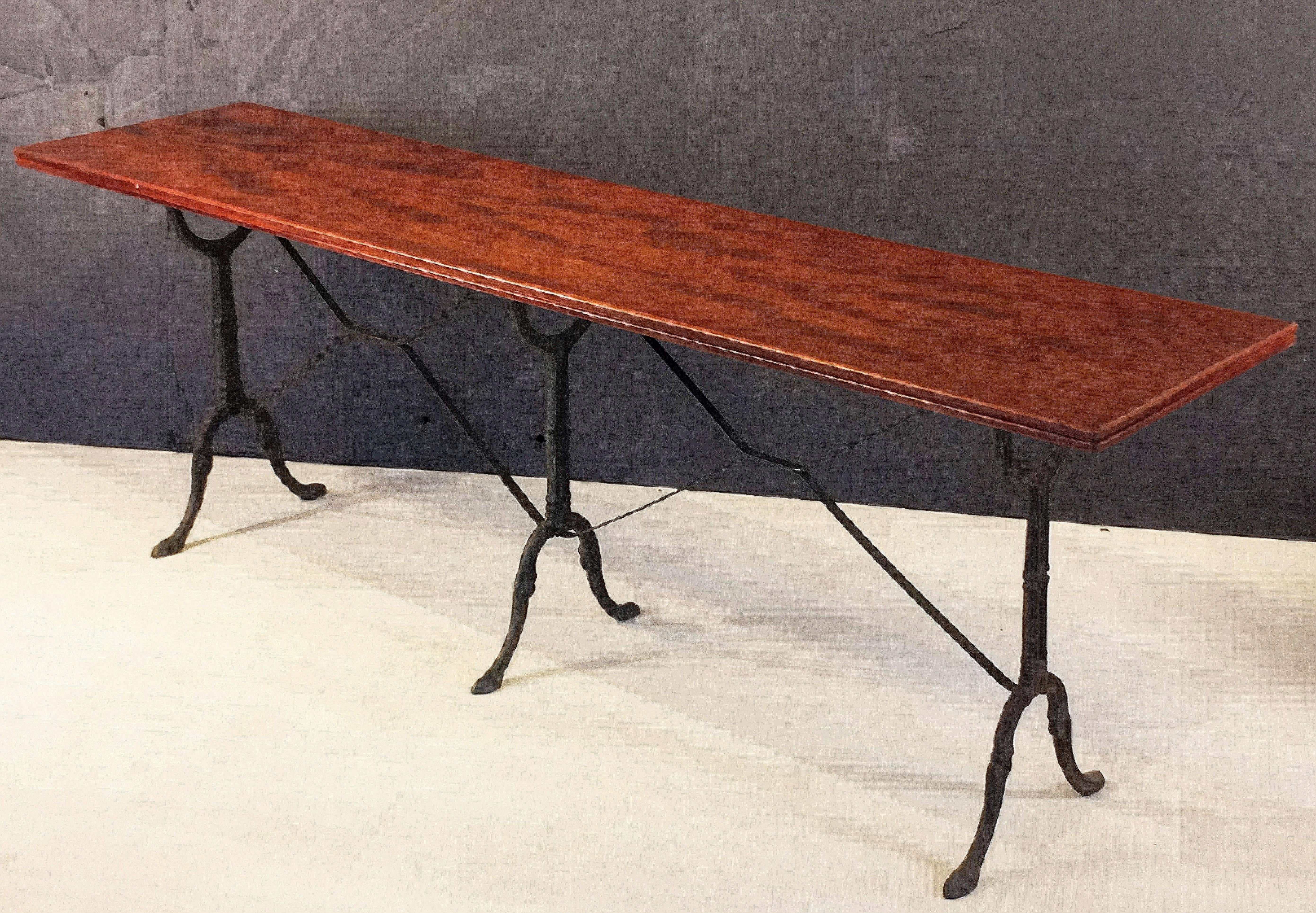 A fine English pub or bistro console table, featuring a moulded rectangular wooden top, set upon a cast iron base with fine scroll work and sturdy feet.

Great as a garden table or serving table!