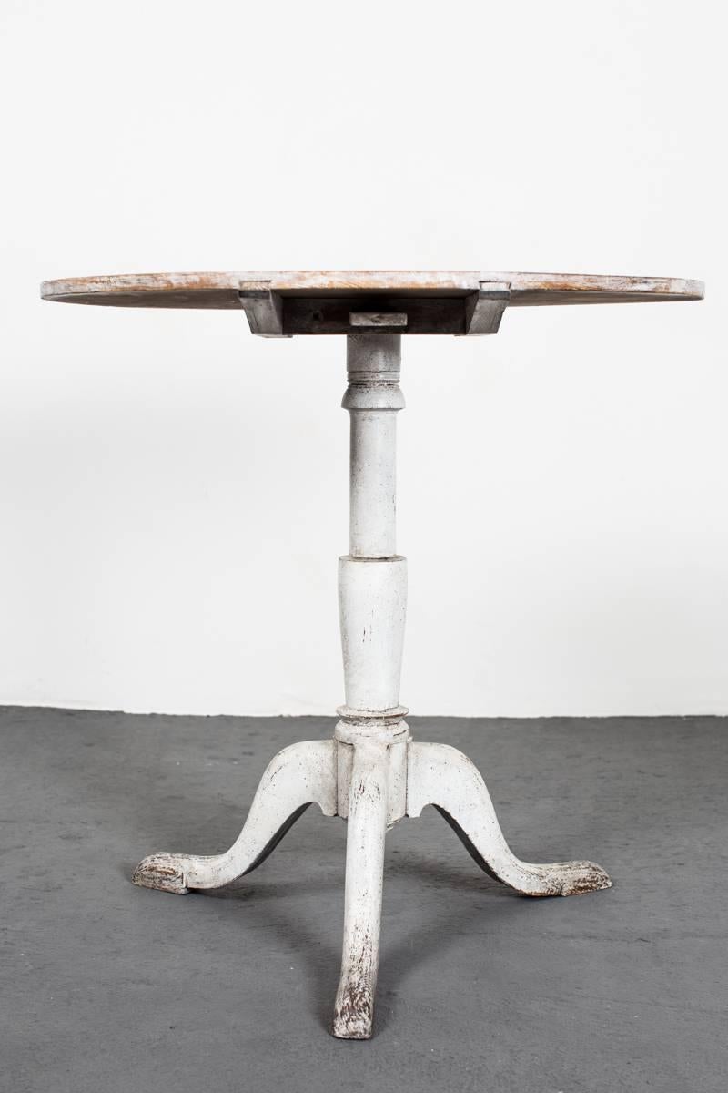 Table Tilt-Top Swedish 19th Century Sweden. A tilt-top table made during the 19th century in Sweden. Round top with a turned base standing on a tripod foot. Later paint. Wear consistent with age and use.
 