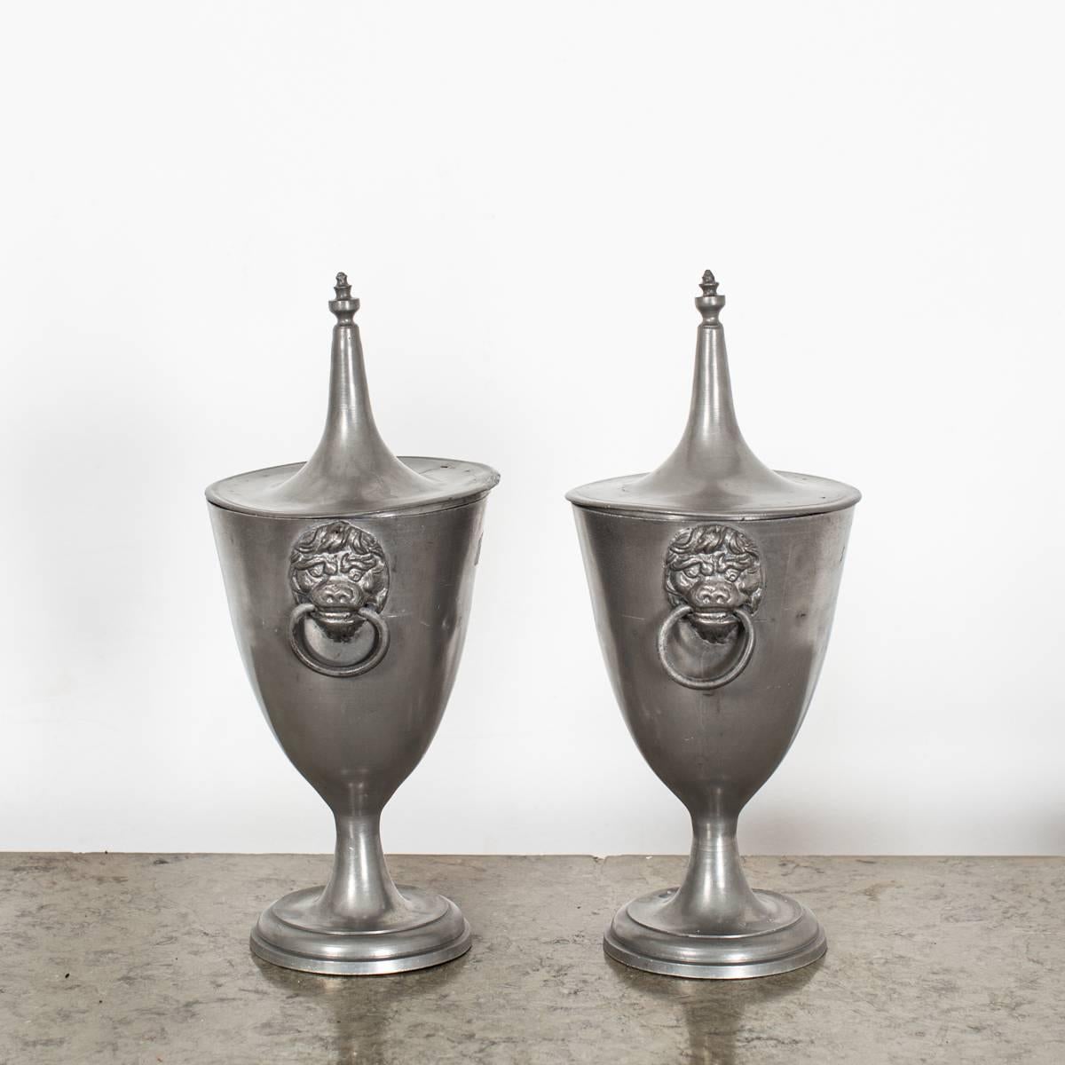 A pair of urns in pewter made during the first half of the 19th century, Empire period in France. Handles decorated with lions heads.