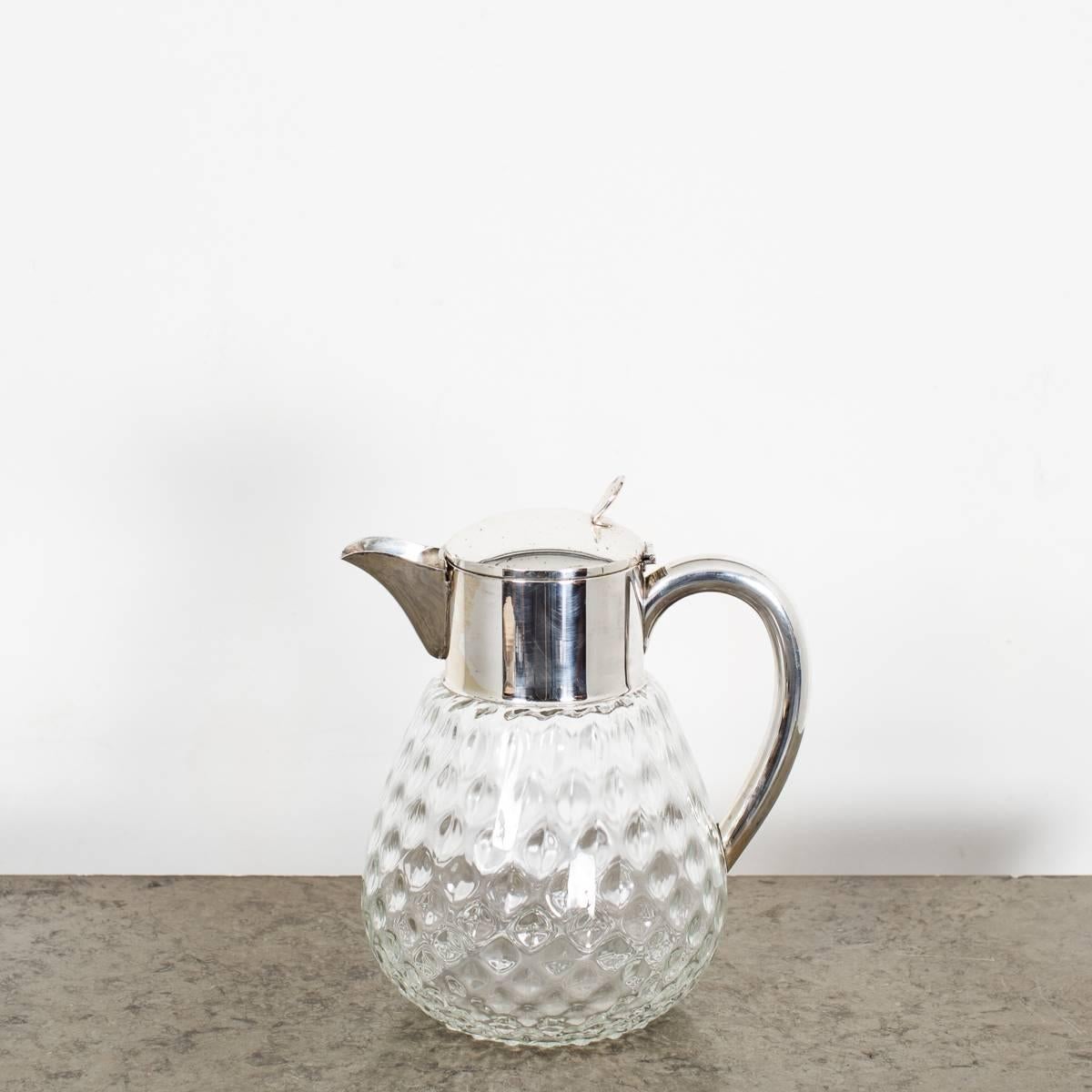 A large pitcher in glass made during the 19th century in Sweden. A patterned glass with a plate top. Removable ice stopper. 

 