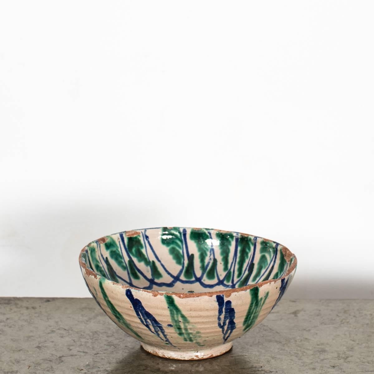 A beautiful bowl made during the 19th century in France. Pottery glazed with a white glaze decorated with a hand-painted blue and green pattern. 

