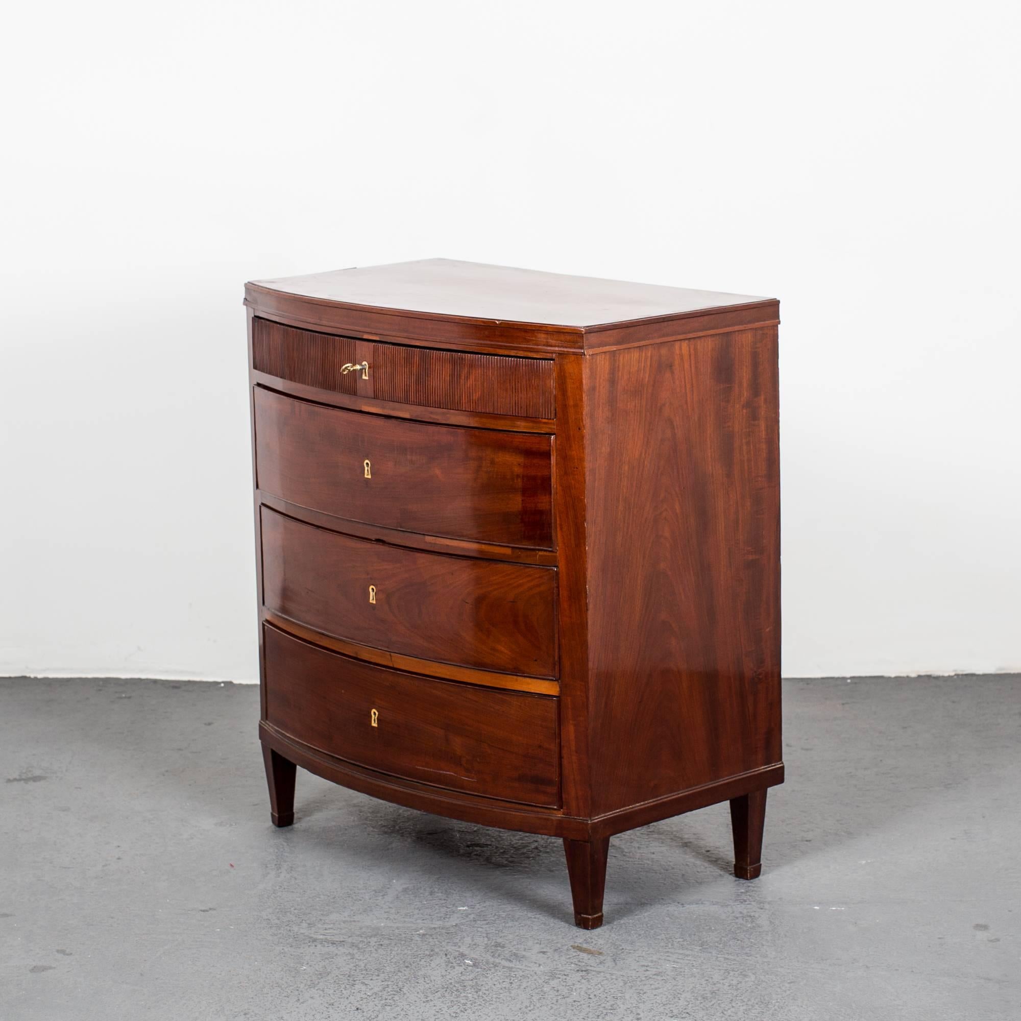 Chest of Drawers Danish Neoclassical Mahogany Denmark. A chest of drawers made during 1790-1810 in Denmark. Frame made of mahogany veneer. Curved front with four drawers with one reeded. Tapered legs.