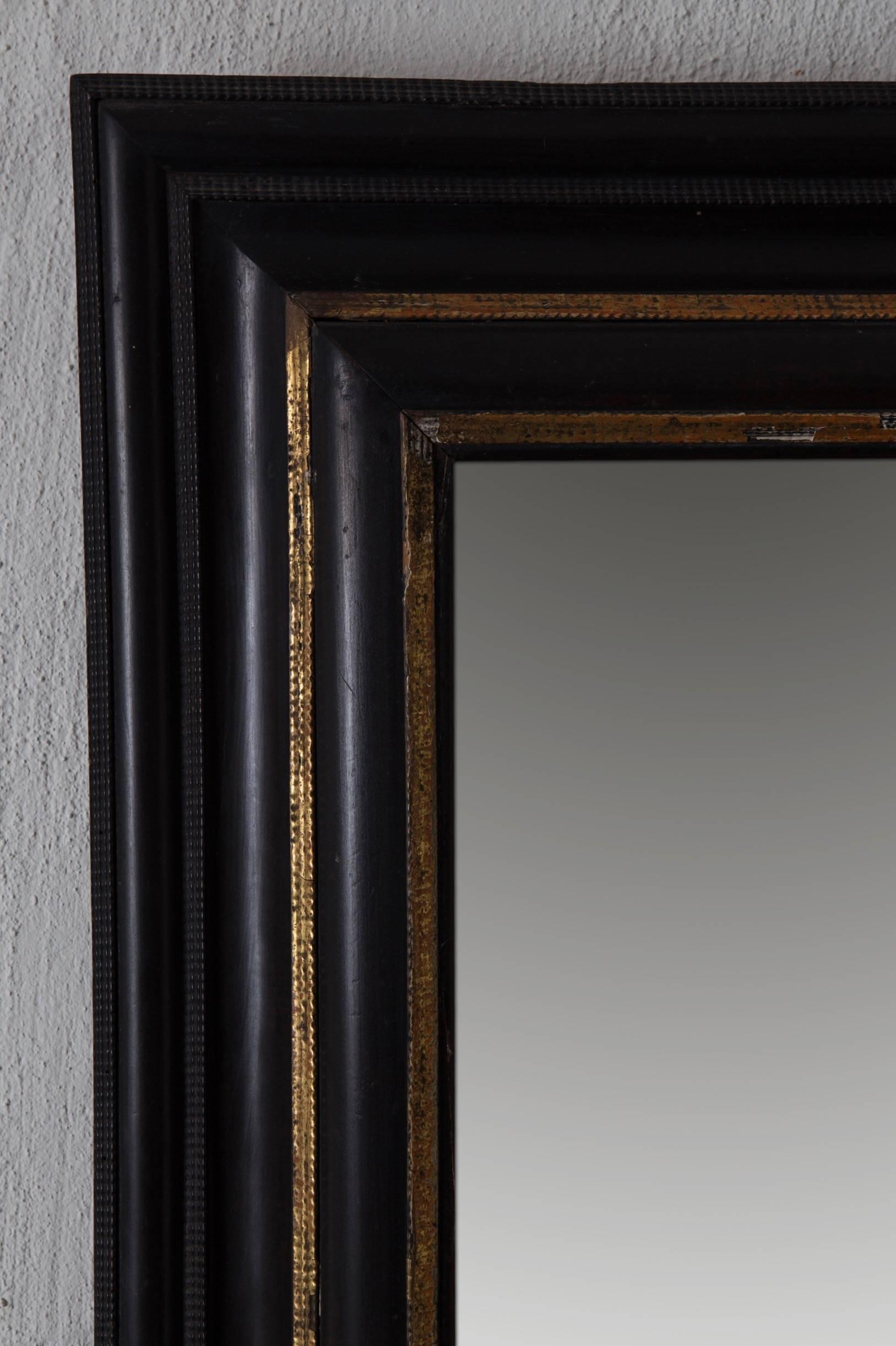 Mirror Baroque Swedish Black Ebonized Gilded Details, 18th Century, Sweden. A mirror made during the Baroque period in Northern Europe. Ebonized (black) frame decorated with gilded details. Old mirror glass. 

 