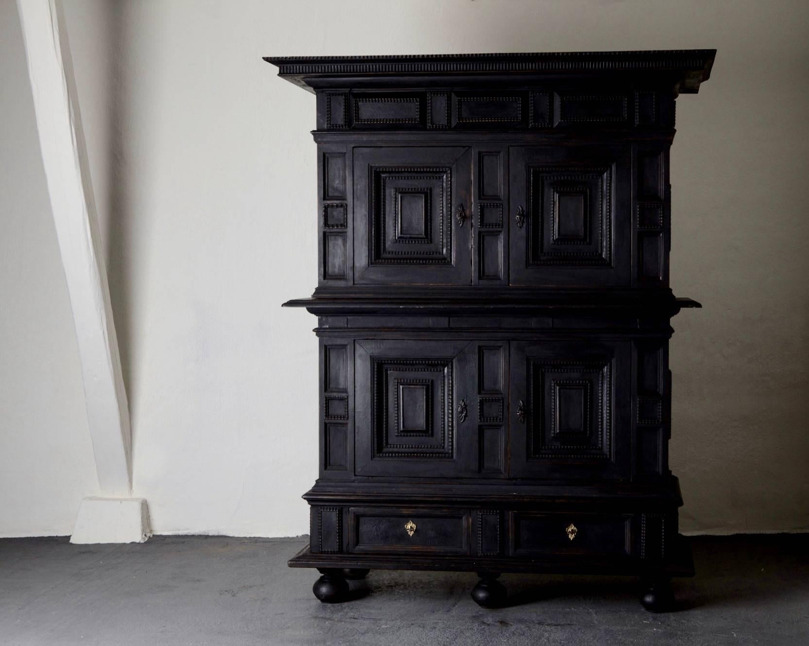 Cabinet Swedish Black Baroque 18th Sweden. A cabinet made during the Baroque period, 18th century in Sweden. Stunning details all according to the Baroque period and 1700's. Top part with 2 cabinet doors and interior with shelving. Base with 2