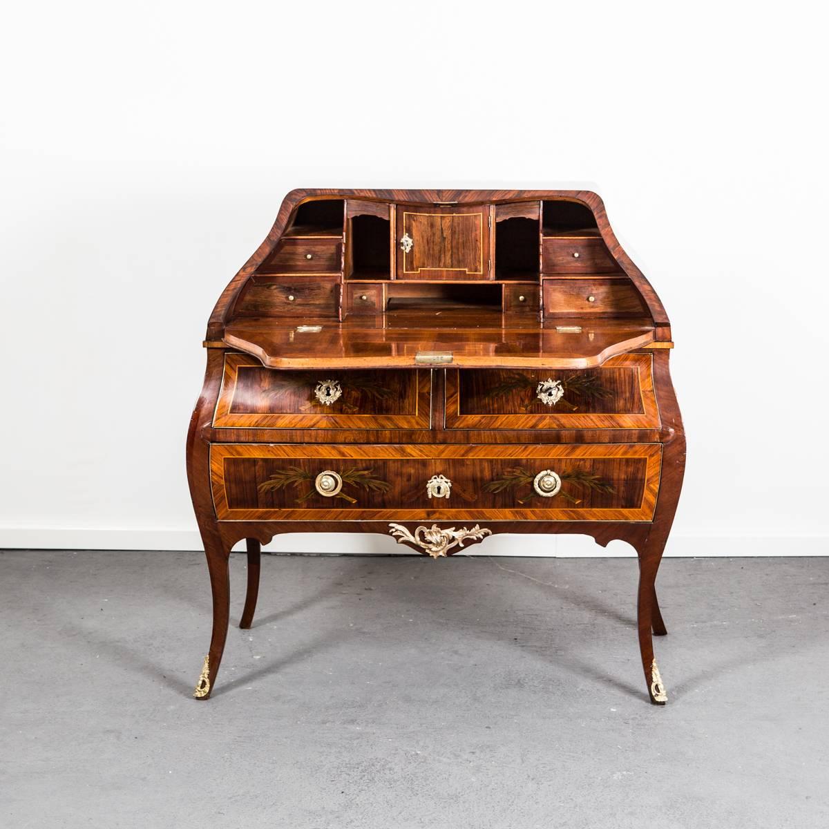 A secretary in highest quality made during the transition between Rococo period and the Gustavian period in Stockholm Sweden 1770-1775. Veneered with rosewood and richly decorated with colored fruit wood with details such as tulip flowers, letters,