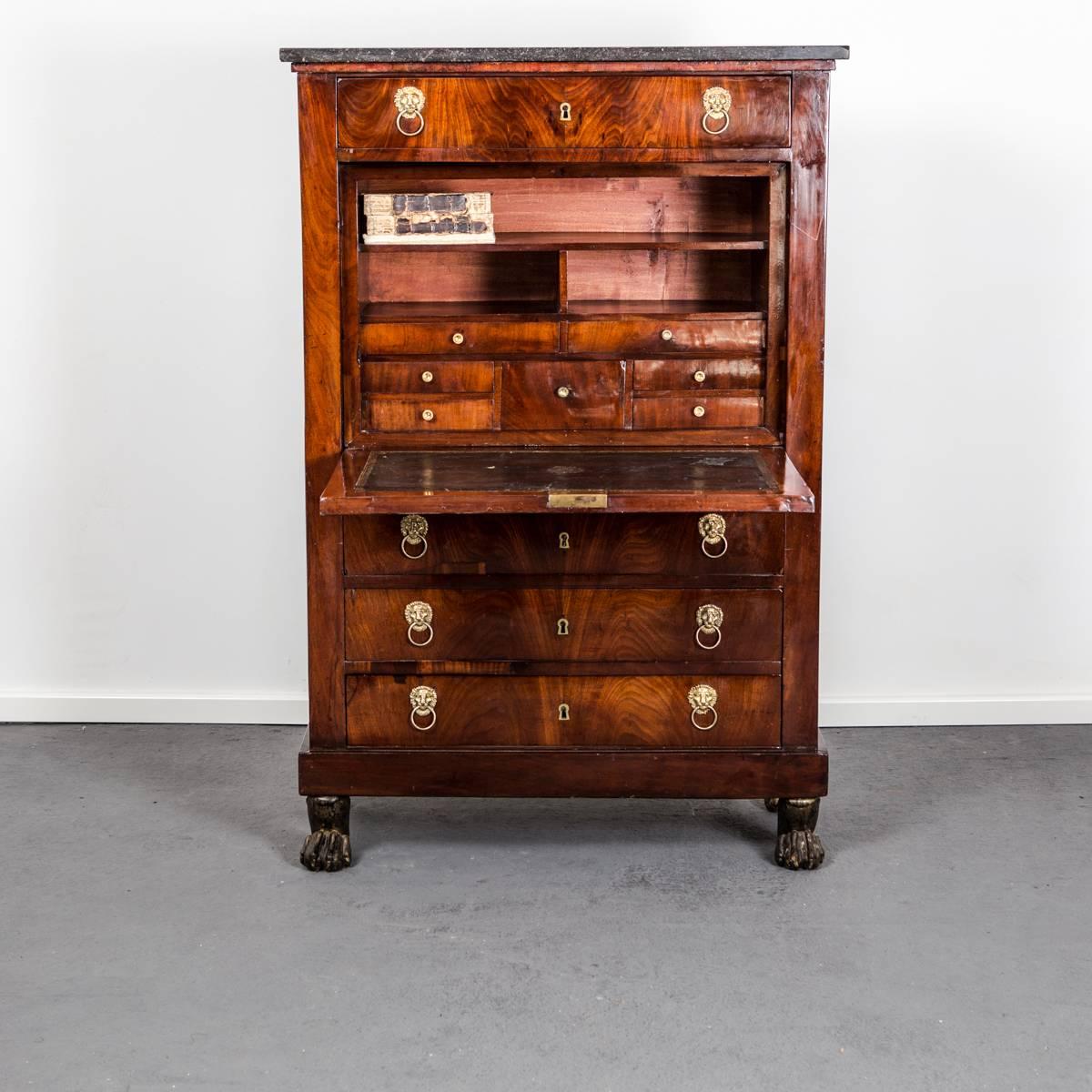 Secretary Empire Neoclassical French 19th Century France. A secretary made during the Empire period 1790-1810 in France. Frame veneered in mahogany. Original hardware in brass shaped as lions heads and wiring desk with a black leather inlay.