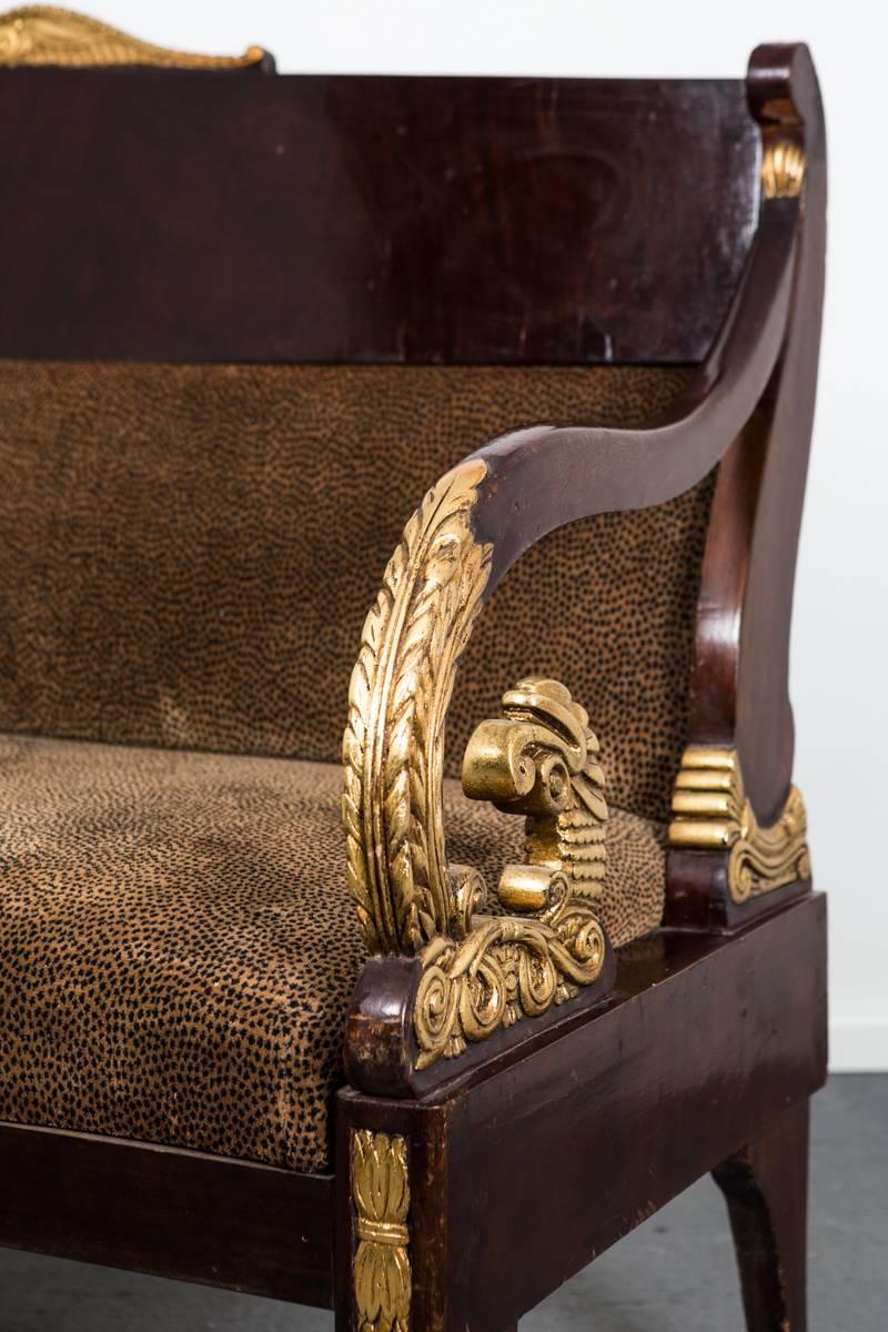 A sofa made during the Empire period end of 18th century in Russia. Restored.  Frame made in mahogany with gilded details. Upholstered in a leopard printed velvet. 

