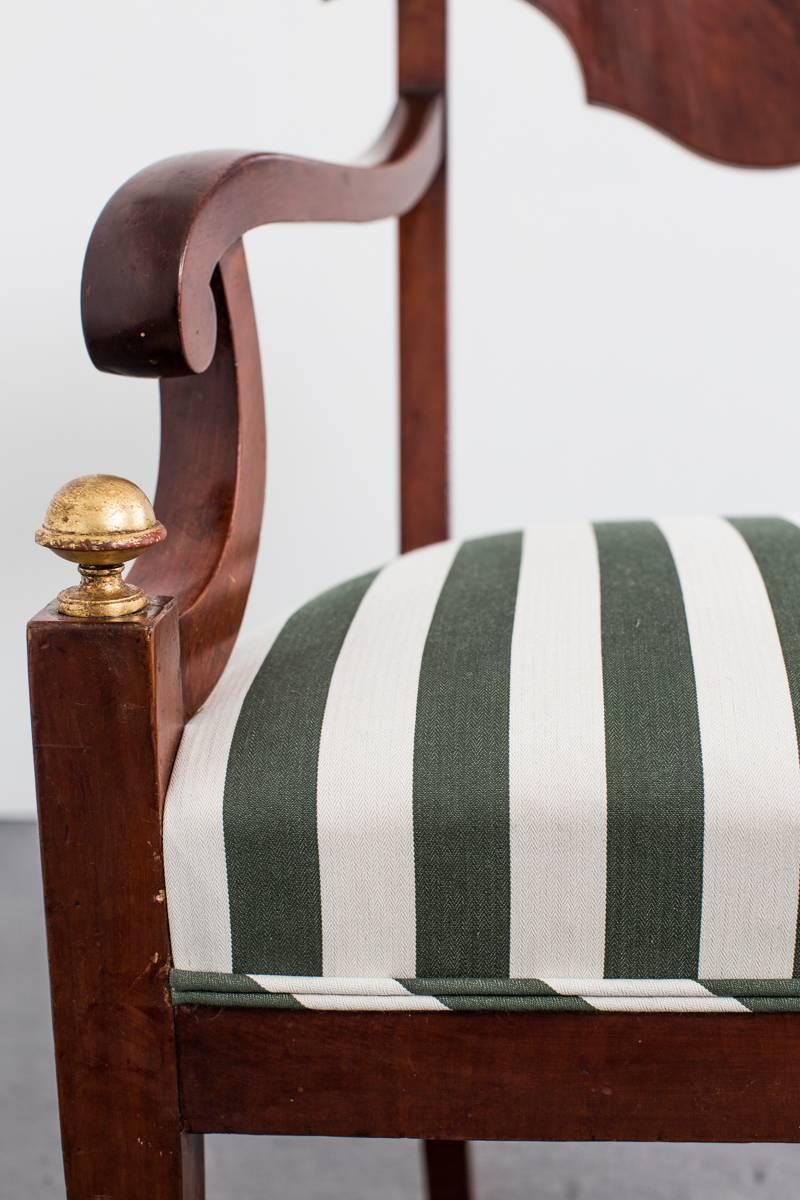 Armchairs Pair Swedish 19th Century Sweden. A pair of handsome armchairs made in Sweden during the Karl Johan period 1810-1840. Frame made in mahogany with gilded details. Upholstered in a durable outdoor Rogers and Goffigon stripe. 


