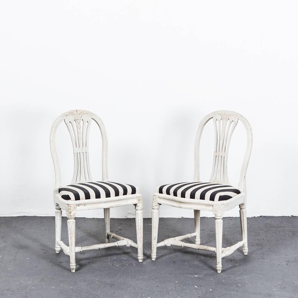 Chairs Side Pair Swedish Gustavian White Chairs. A pair of Swedish High Gustavian side chairs made during 1775-1790 in Sweden. Seats upholstered in a black and white striped cotton fabric. Frame in a distressed white painted finish. 