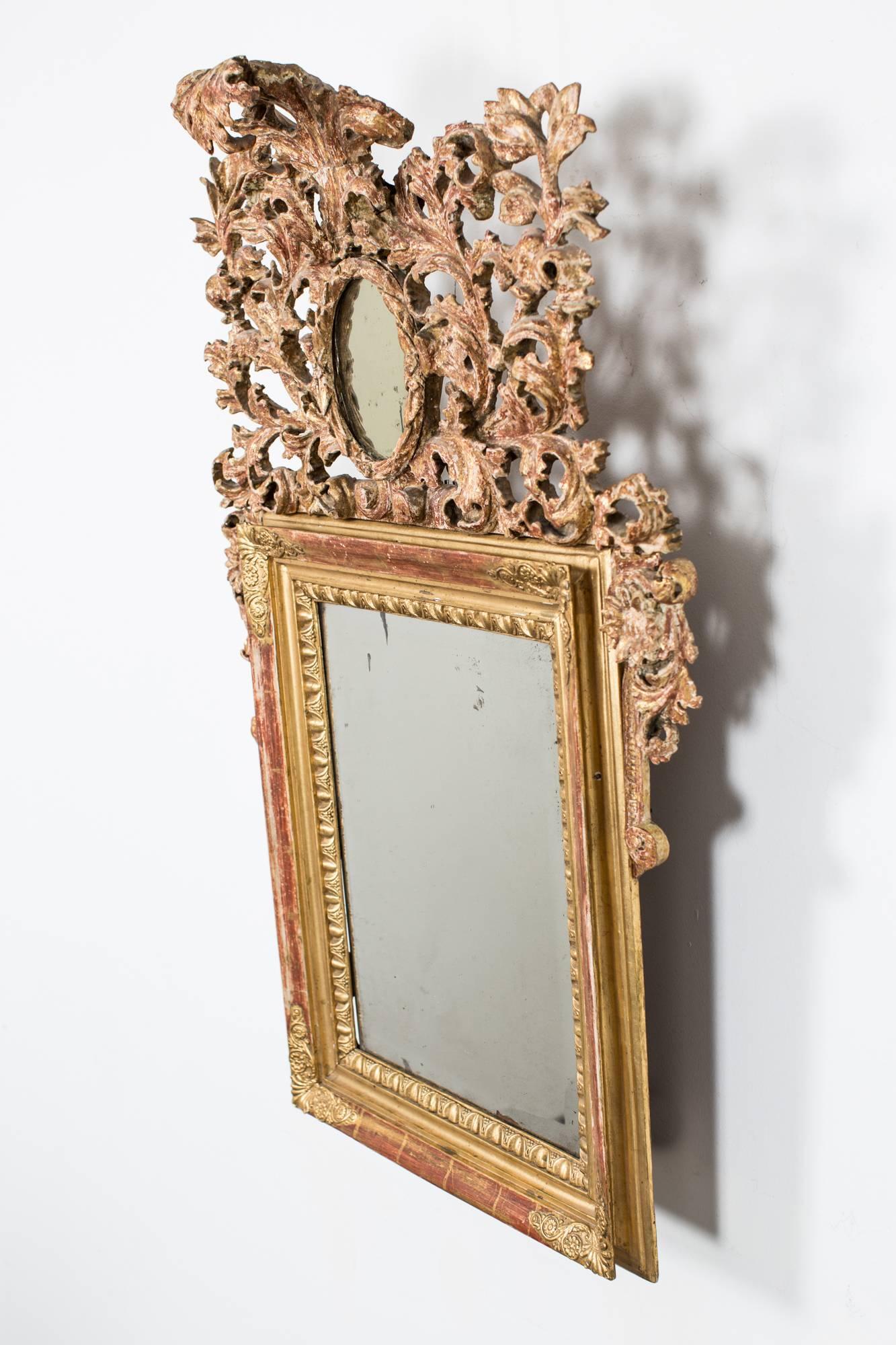 A wall mirror made during the Baroque period in Northern Europe. Original gilding. New mirror glass.