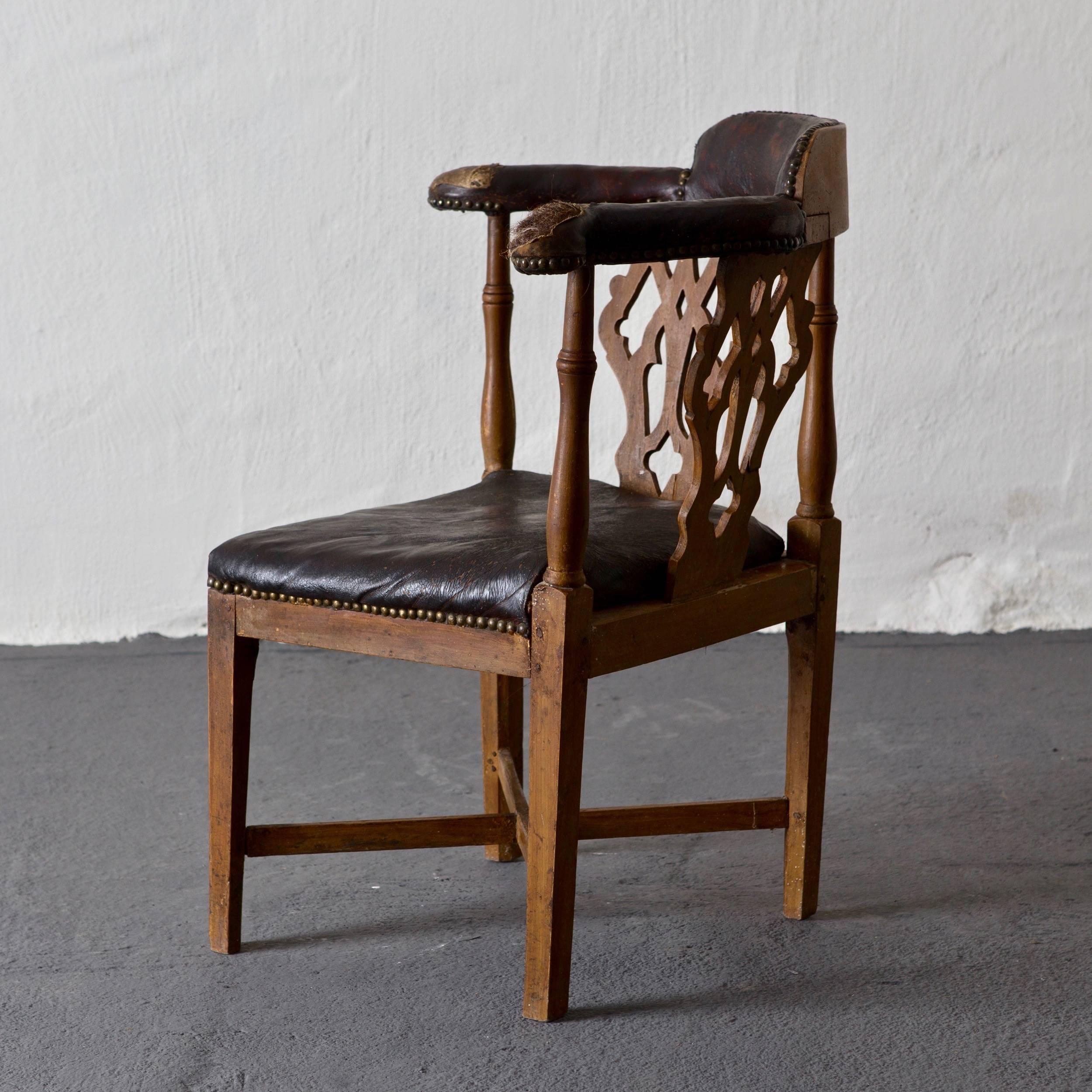 Chair Swedish leather 1775-1790 Sweden. Made during the transition between the Rococo period and Gustavian period. Frame made from beech wood and a seat, back and armrests in worn leather, original to the chair. Measurement from corner to front: 18