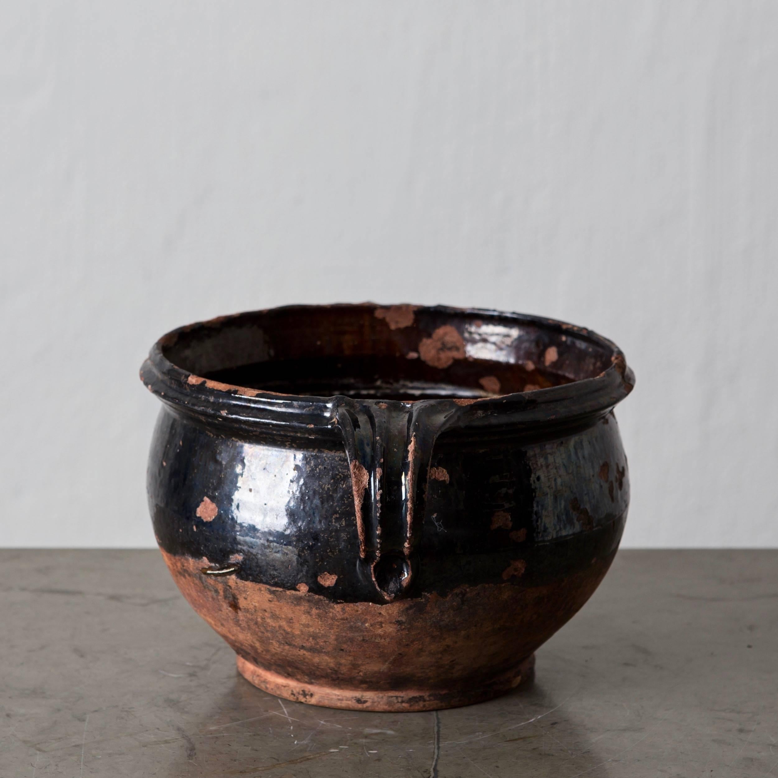 A terracotta jar pot with black salt glaze made in southern Sweden during the 19th century.