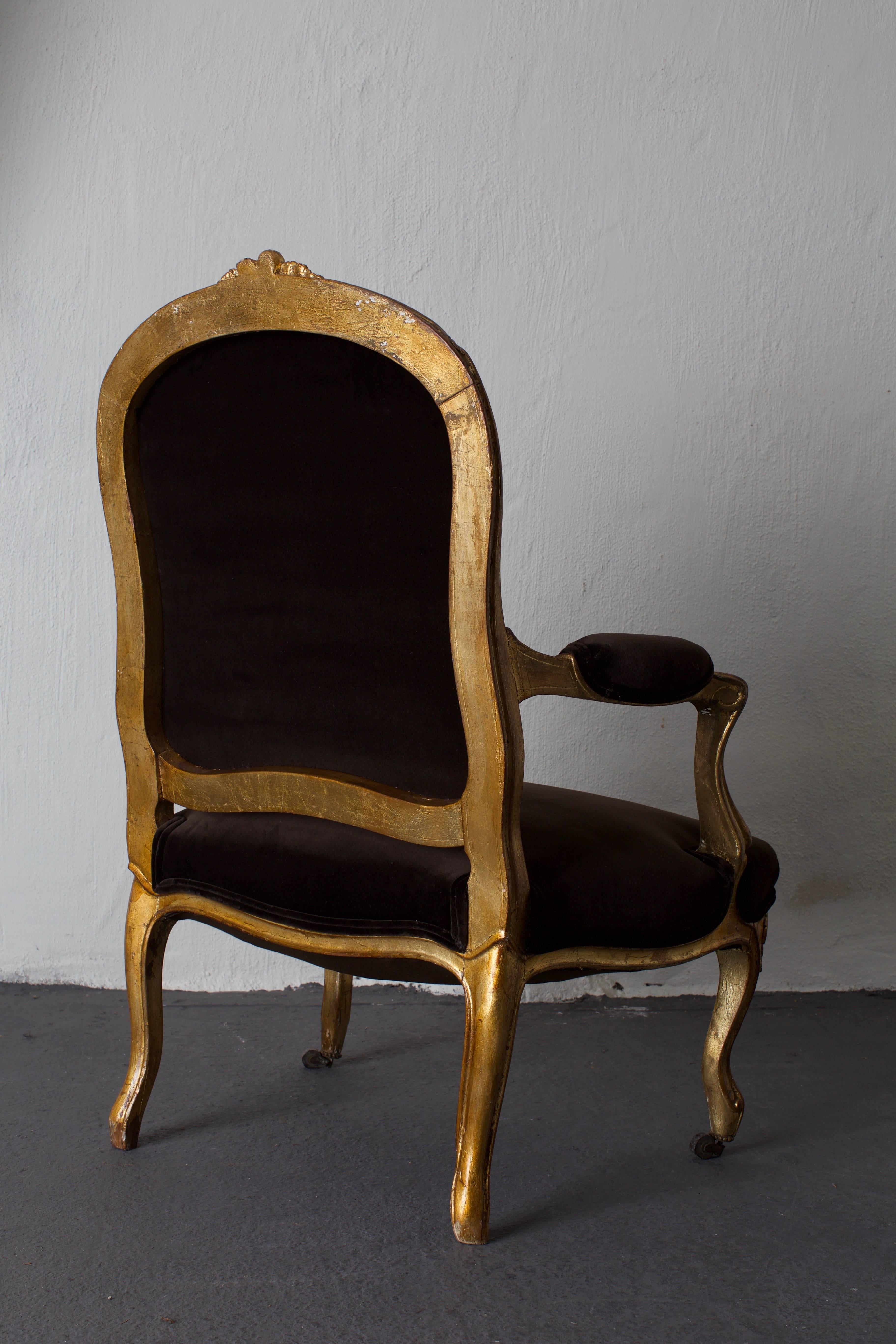 Armchair French giltwood Rococo style France. An armchair made during the 19th century in France. Frame of giltwood with beautiful carvings. Contemporary upholstery in dark brown cotton velvet with double piping.