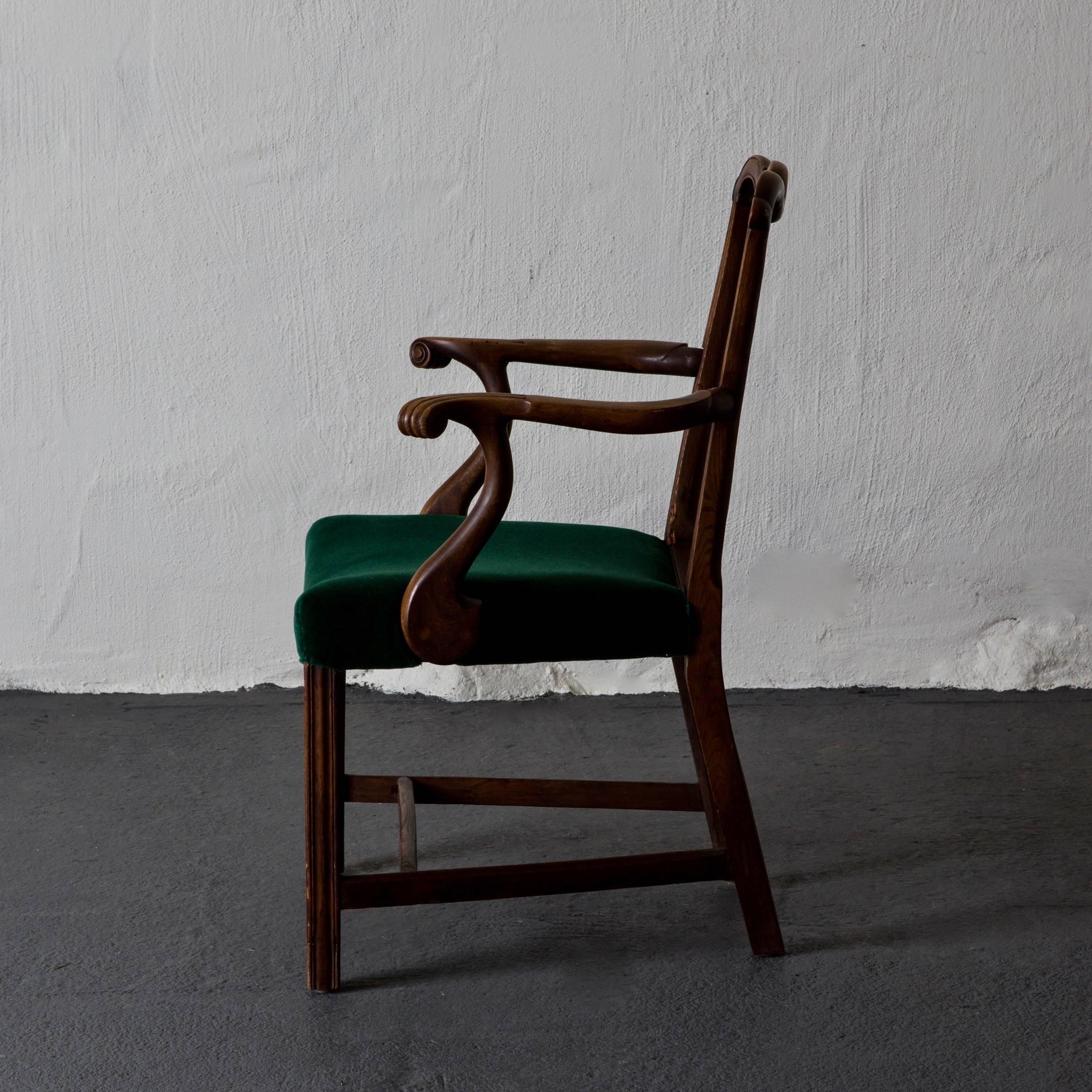 An armchair made during the 19th century in England. Frame made from mahogany. Upholstered in a green mohair velvet. 