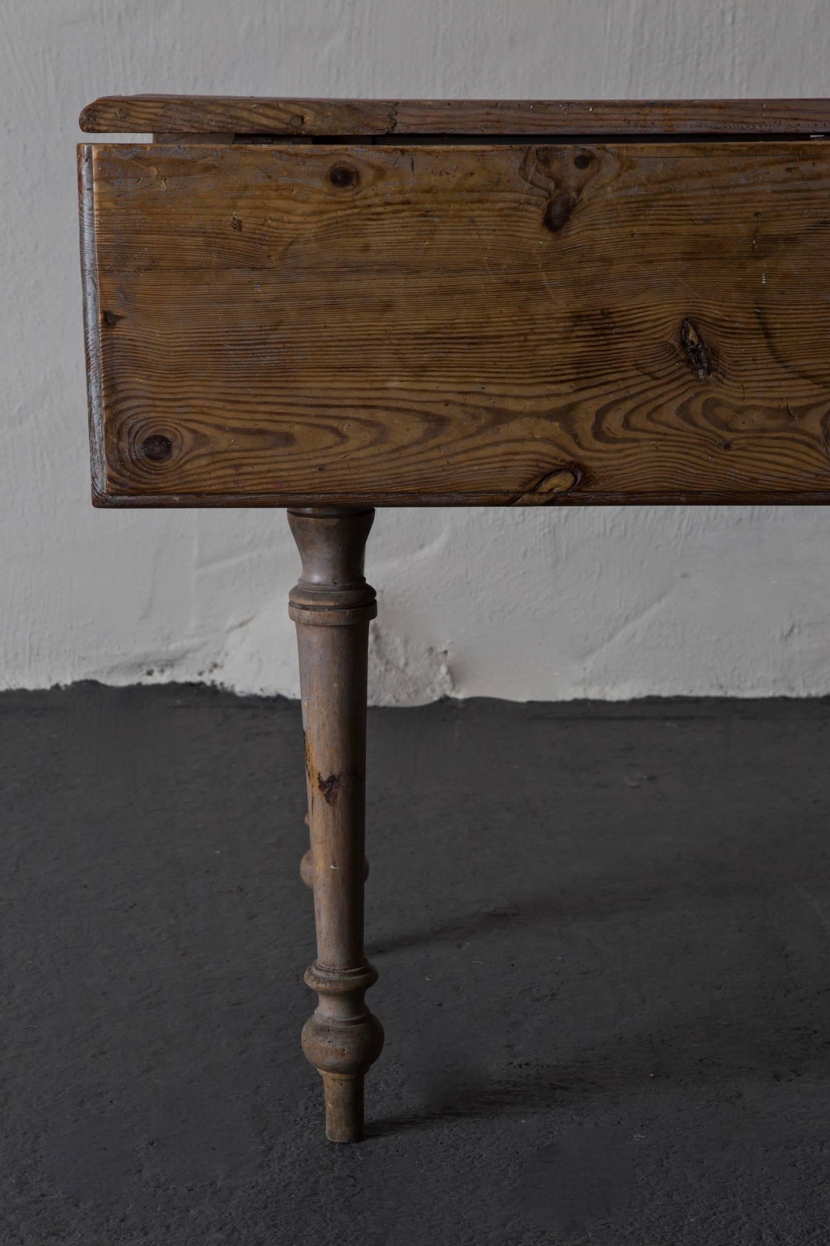 A drop leaf table made during the 19th century in Sweden. Drawer on one end. Original paint. 