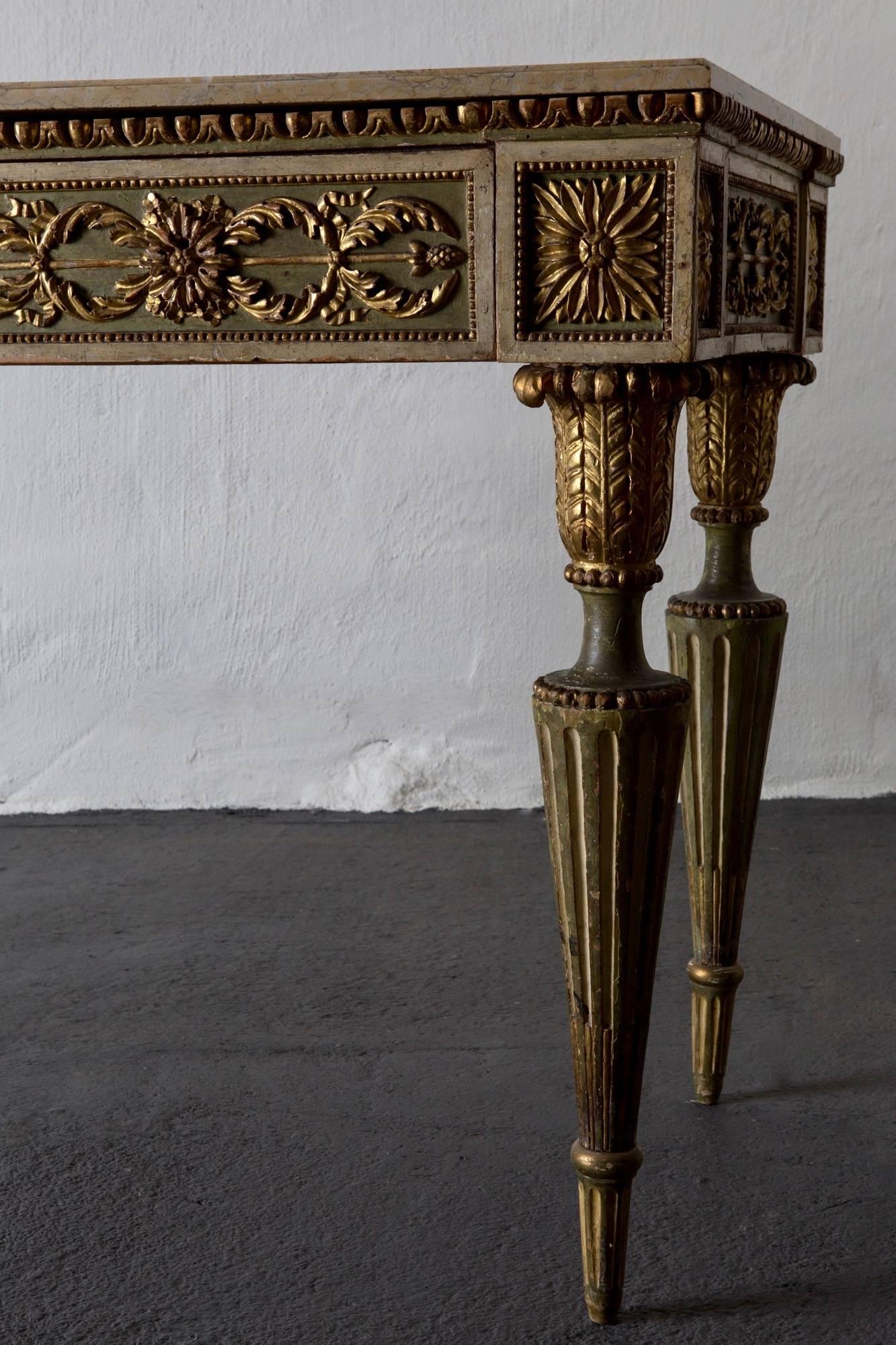 Console table Italian large polychrome paint green gilded 18th century, Italy. A large console table made during the 18th century in Italy. Polychromed painted in a dusty green with gilded details. Marble top. Drawer in frieze. Decorated with