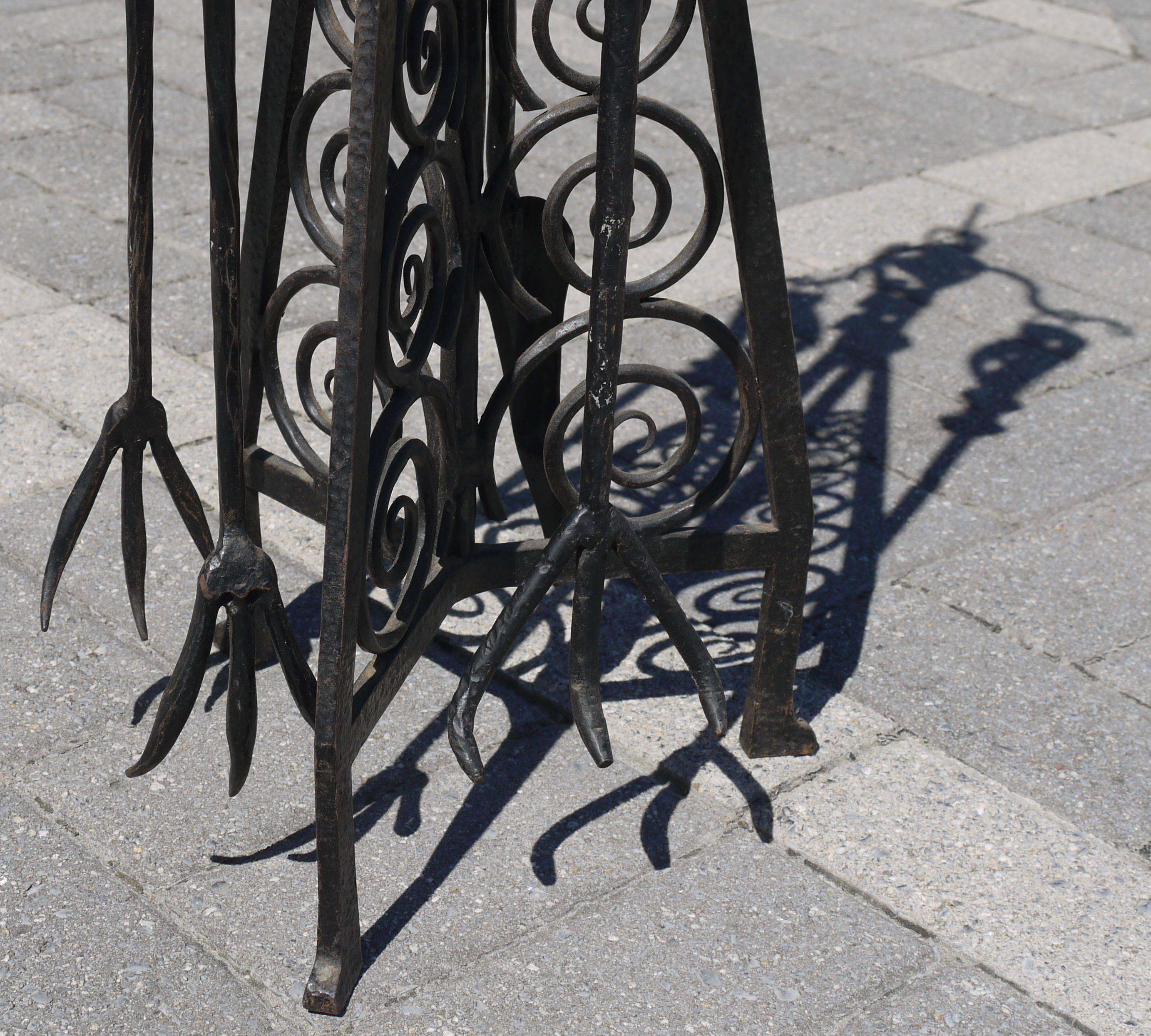 Outstanding quality and superior craftsmanship make this forged iron Art Deco toolset stand apart from others. Its sculptural shape and larger architectural scale really make this fireplace set a winner. It has many hallmarks of the work of Paul