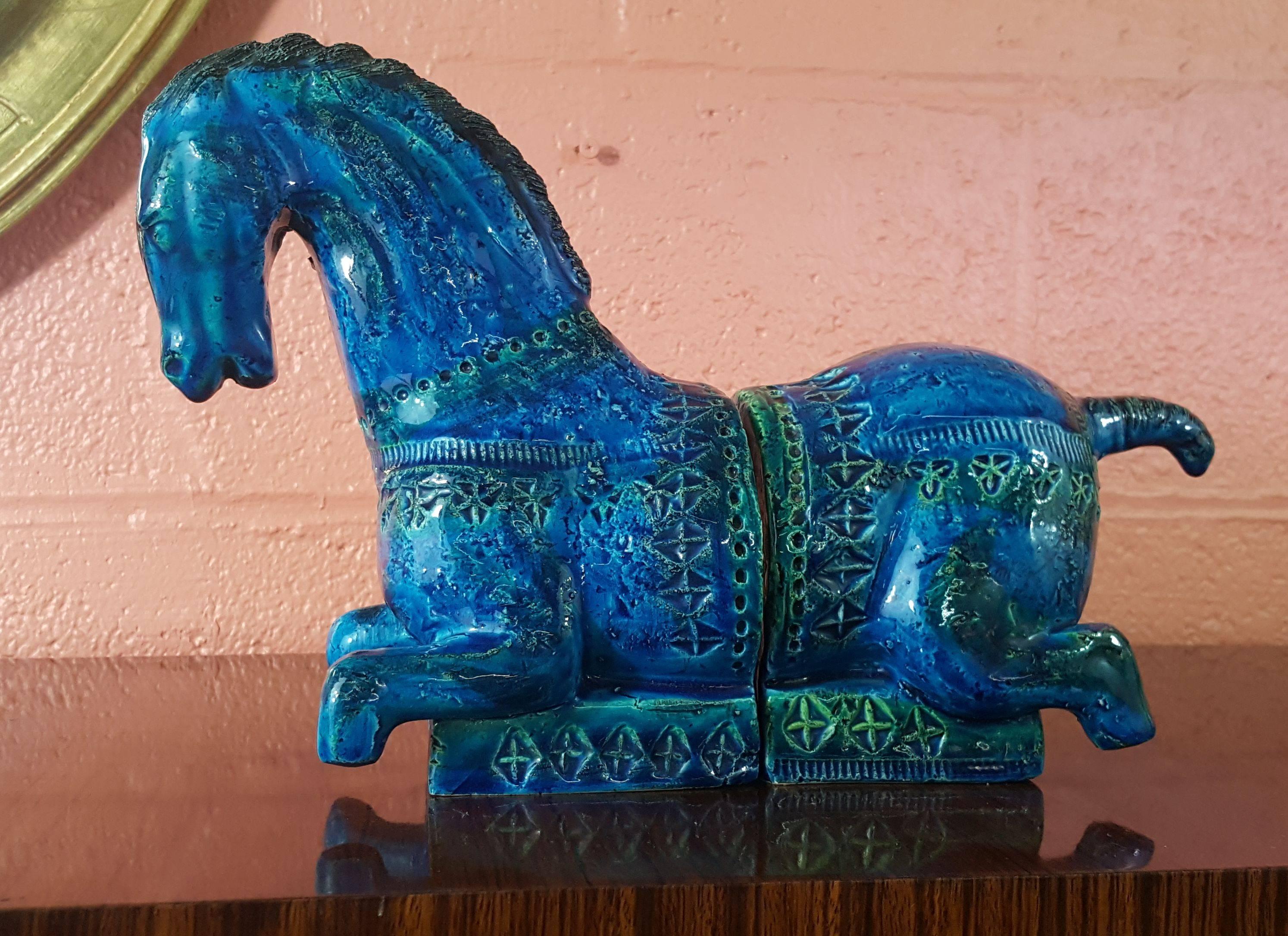 Wonderful bookends by Aldo Londi for Bitossi, circa 1963 in Rimini Blue. The form was stylized after a chinese tang dynasty horse in stride. Color on this one is absolutely amazing.