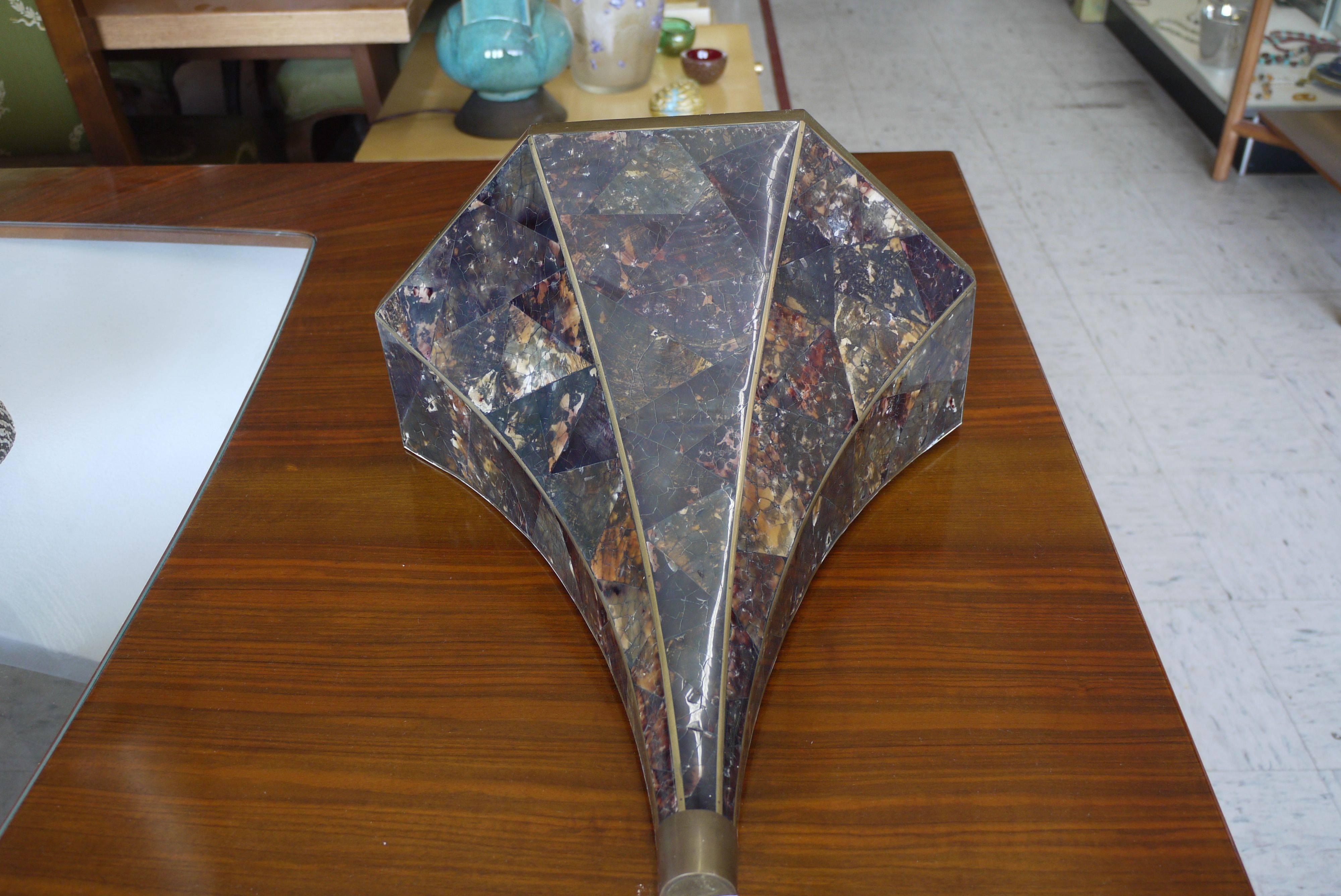 Absolutely stunning set of Maitland-Smith sconces done in penshell which has the appearance of tortoiseshell. Great Art Deco style with inlaid shell and pegged brass strips. Inside of sconce is covered in brass so they'll emit a nice warm glow.