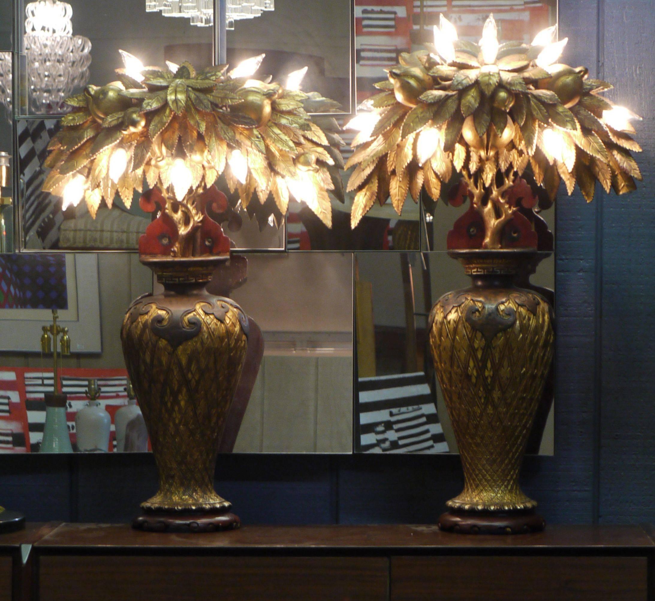 Wonderful pair of whimsical Tony Duquette style lamps made from antique Chinese parts and pieces put together in the 1920s. These were originally wall-mounted sconces but have been redrilled and wired internally so they can be used as table lamps.