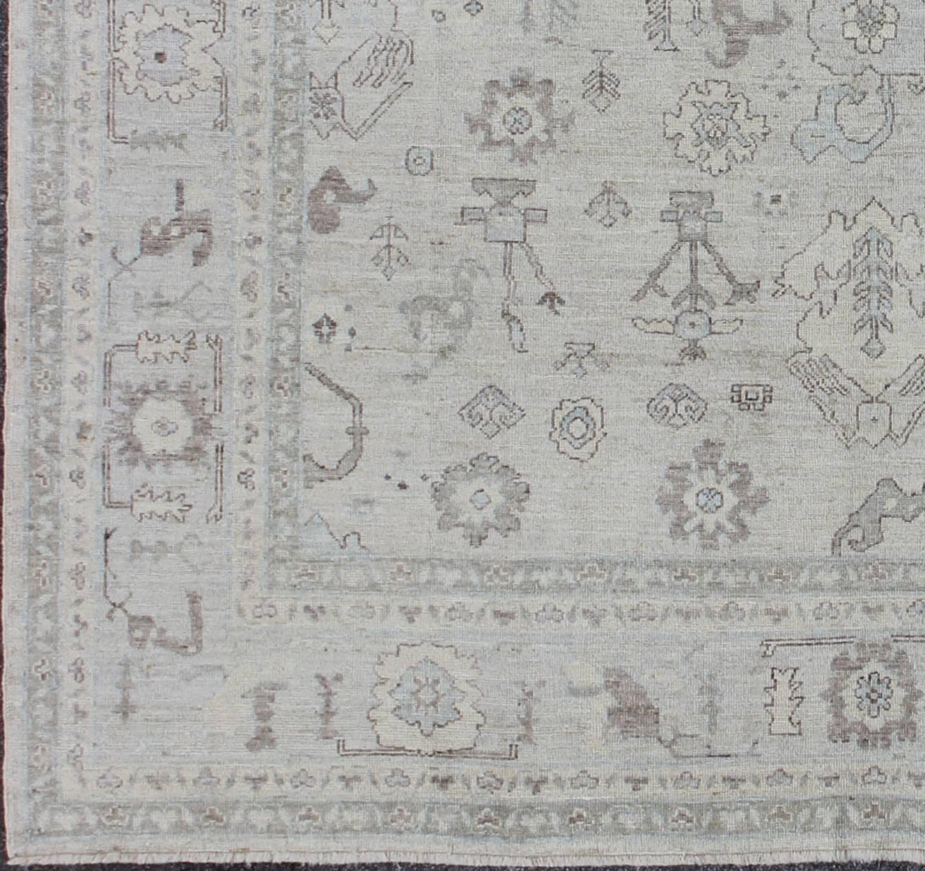 Made with a combination of angora and old wool, this magnificent Oushak boasts an all-over design in a large scale style. The plentiful floral and bouquet motifs creates an open design which is surrounded by a border containing defined and geometric