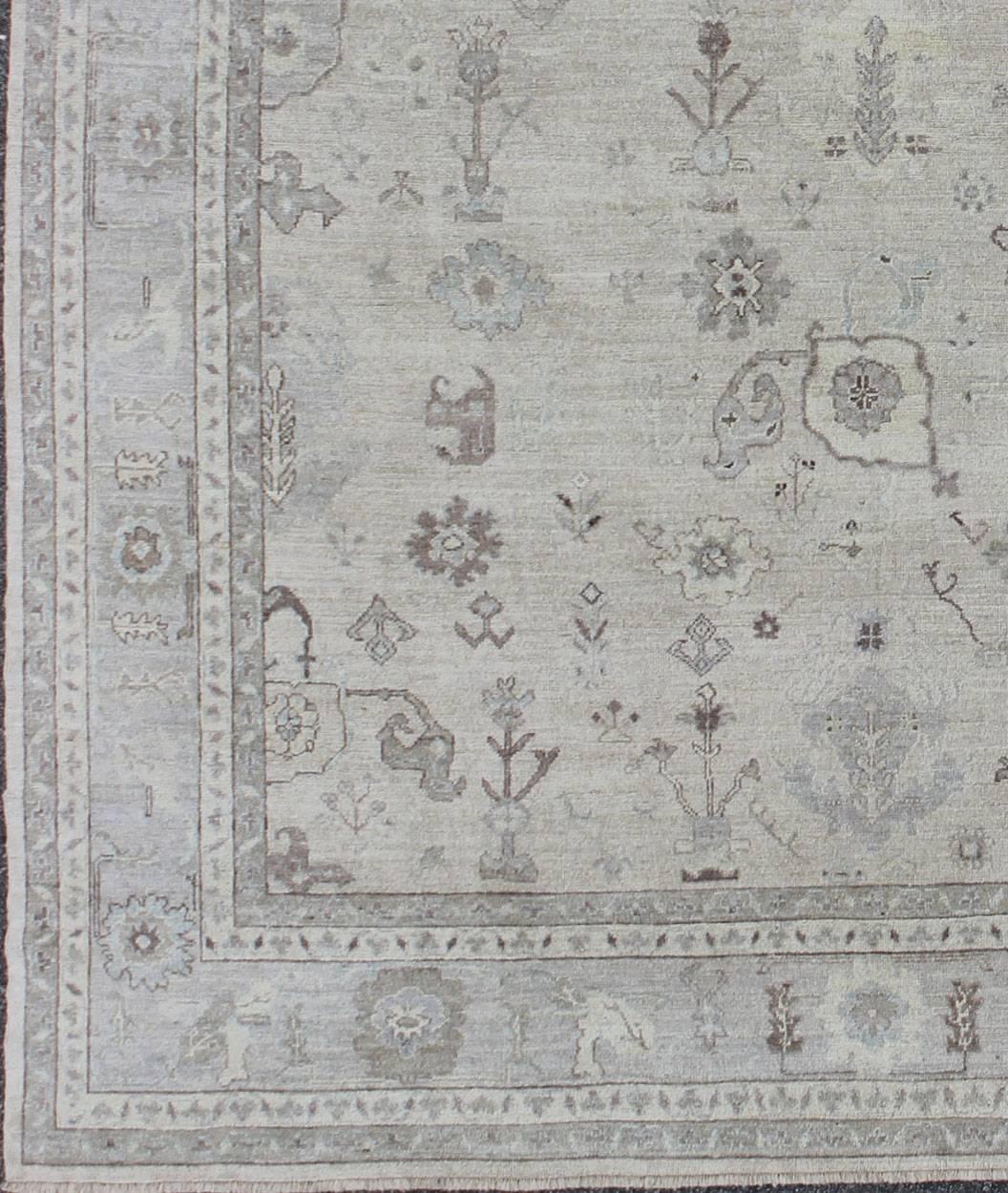 Made with a combination of angora and old wool, this magnificent vintage Turkish Oushak boasts an all-over design in a large-scale style. The plentiful floral and bouquet motifs create an open design, which is surrounded by a border containing