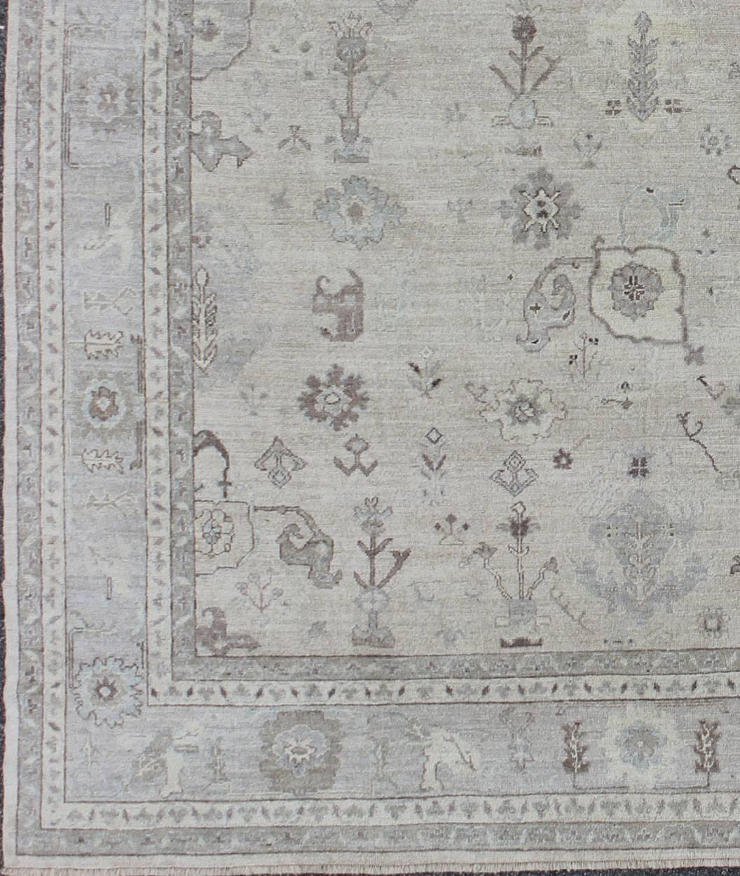 Made with a combination of angora and old wool, this magnificent vintage Turkish Oushak boasts an all-over design in a large-scale style. The plentiful floral and bouquet motifs create an open design, which is surrounded by a border containing