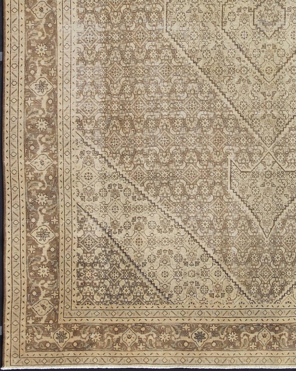 Traditional medallion and vine designs are expressed in a muted palette of neutral wheat and taupe hues, with splashes of dark brown punctuating the overall design of this Tabriz rug from the first part of the 20th Century.
Measures: 9'9 x 12'4.