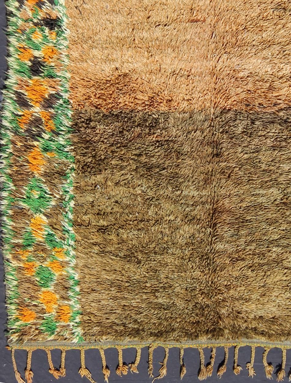 A vibrant color palette of teal and mossy-brown green with flecks of gold highlights complement the simple design of this vintage Moroccan piece.

Measures: 5'6 x 9'1.