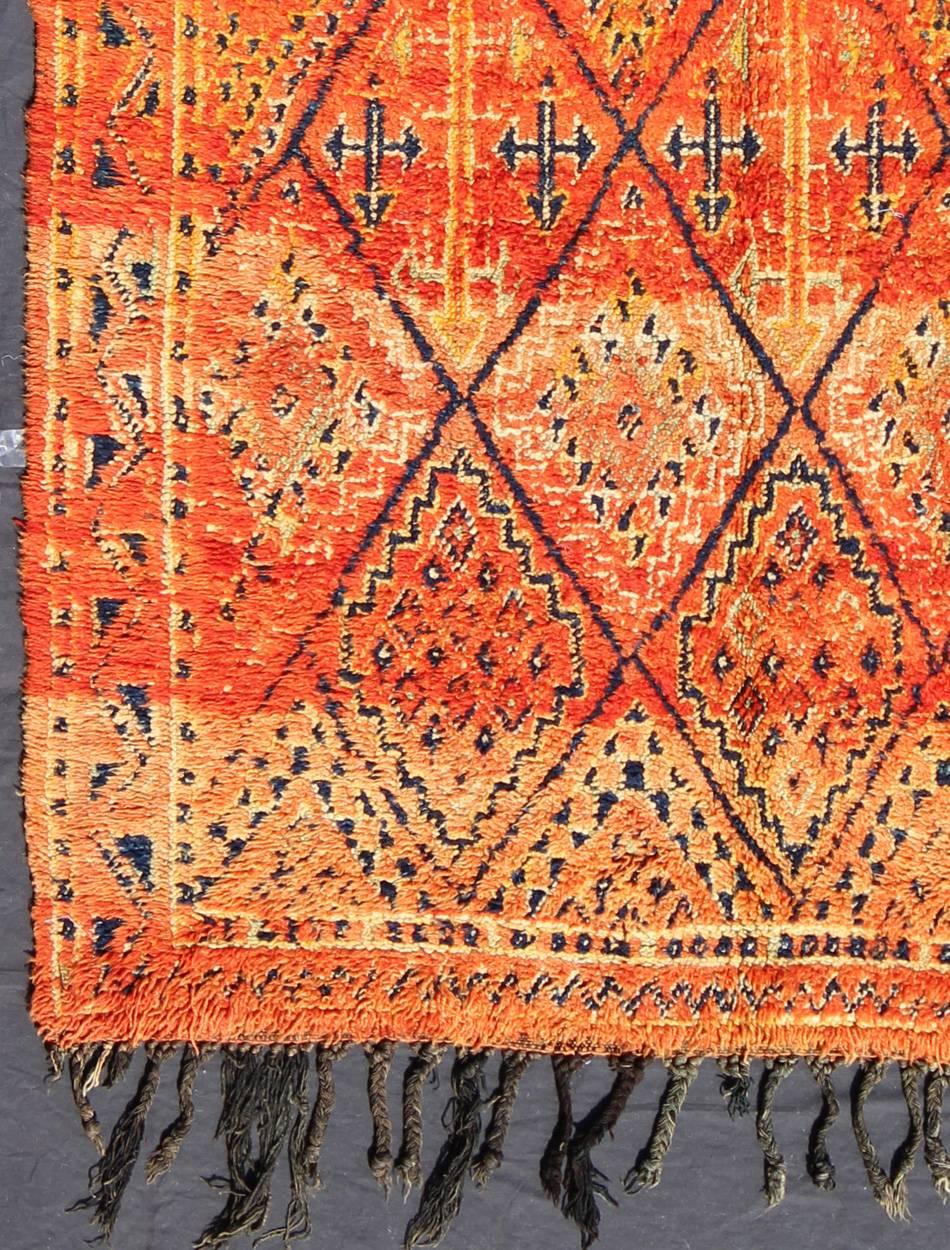 Measures: 5'11'' x 10'4''.
Woven on a gorgeous luscious black wool base, this original vintage carpet features finely structured diamonds flanked by skillfully woven symbols. Key colors include burnt orange, tangerine and cream with touches of deep