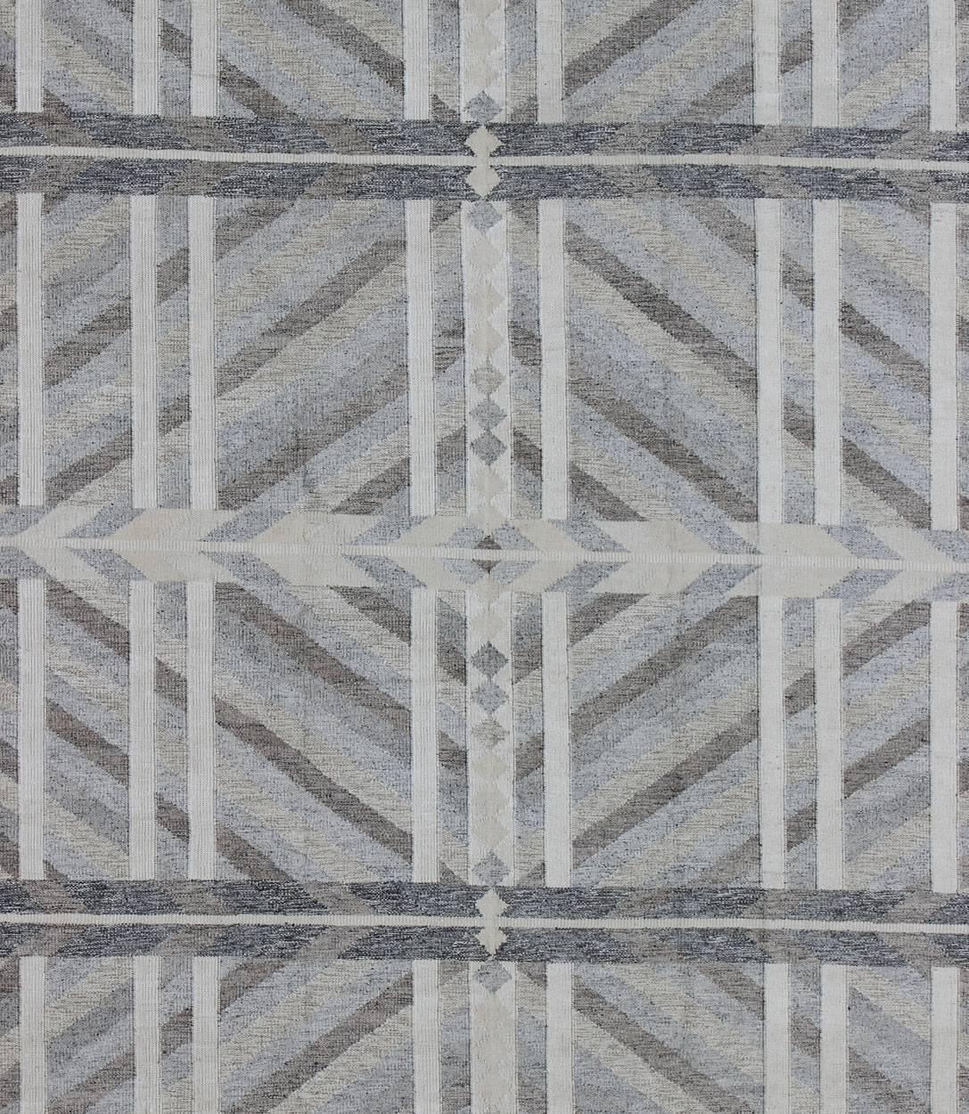 Large Modern Scandinavian/Swedish Geometric Rug in Gray and Pastel Colors.
This large Scandinavian flat-weave rug is inspired by the work of Swedish textile designers of the early to mid-20th century. With a unique blend of historical and modern