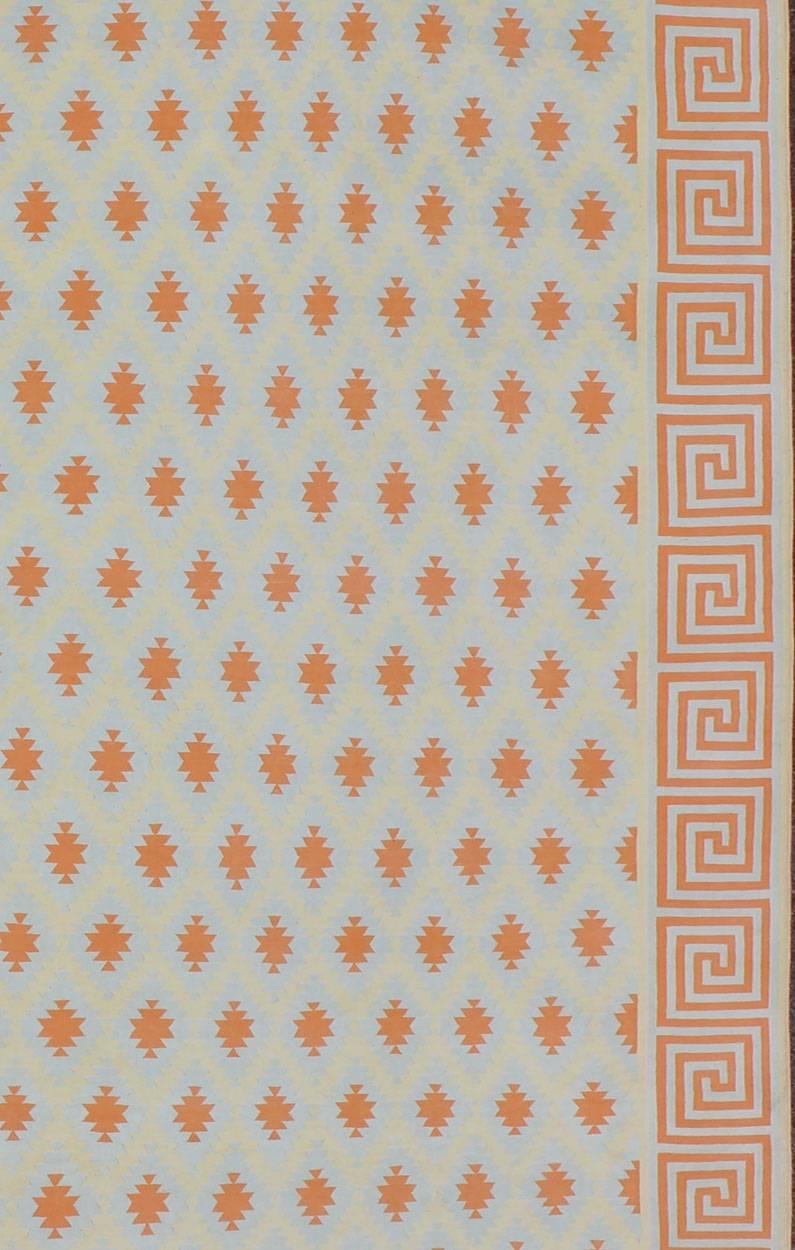 Woven during the mid-20th century, this designer cotton dhurrie is decorated with a stepped diamond pattern rendered with an inventive low-contrast color palette. This flat-woven Indian dhurrie features repeating geometric motifs in a tasteful