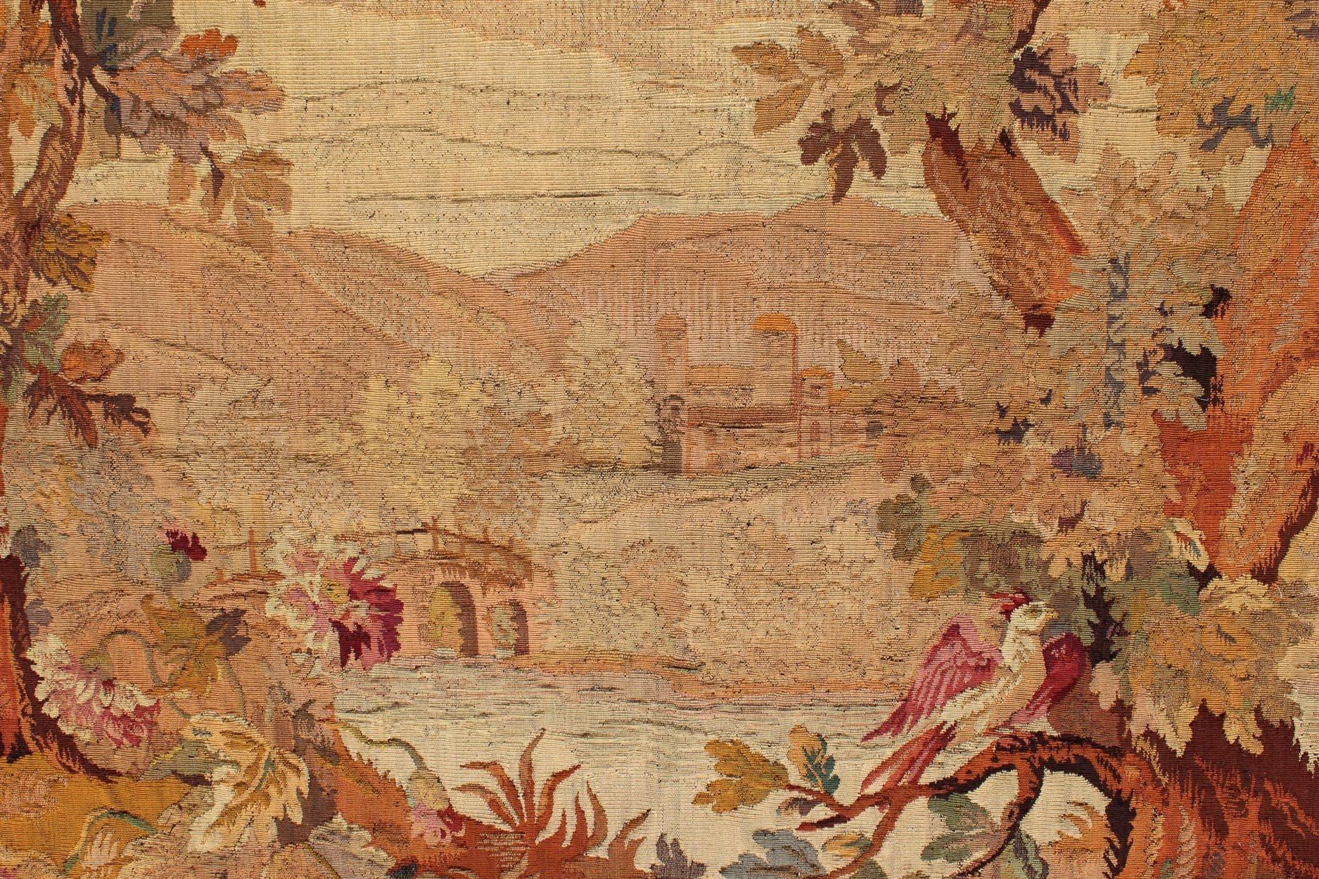 Antique French Landscape Tapestry Overlooking a River/Pond, Bridge in Autumnal Colors and Floral Border. Antique French Tapestry Two Trees Overlooking a River Bridge in Autumnal Colors, Keivan Woven Arts / rug;  N15-0503,  country of origin / type: