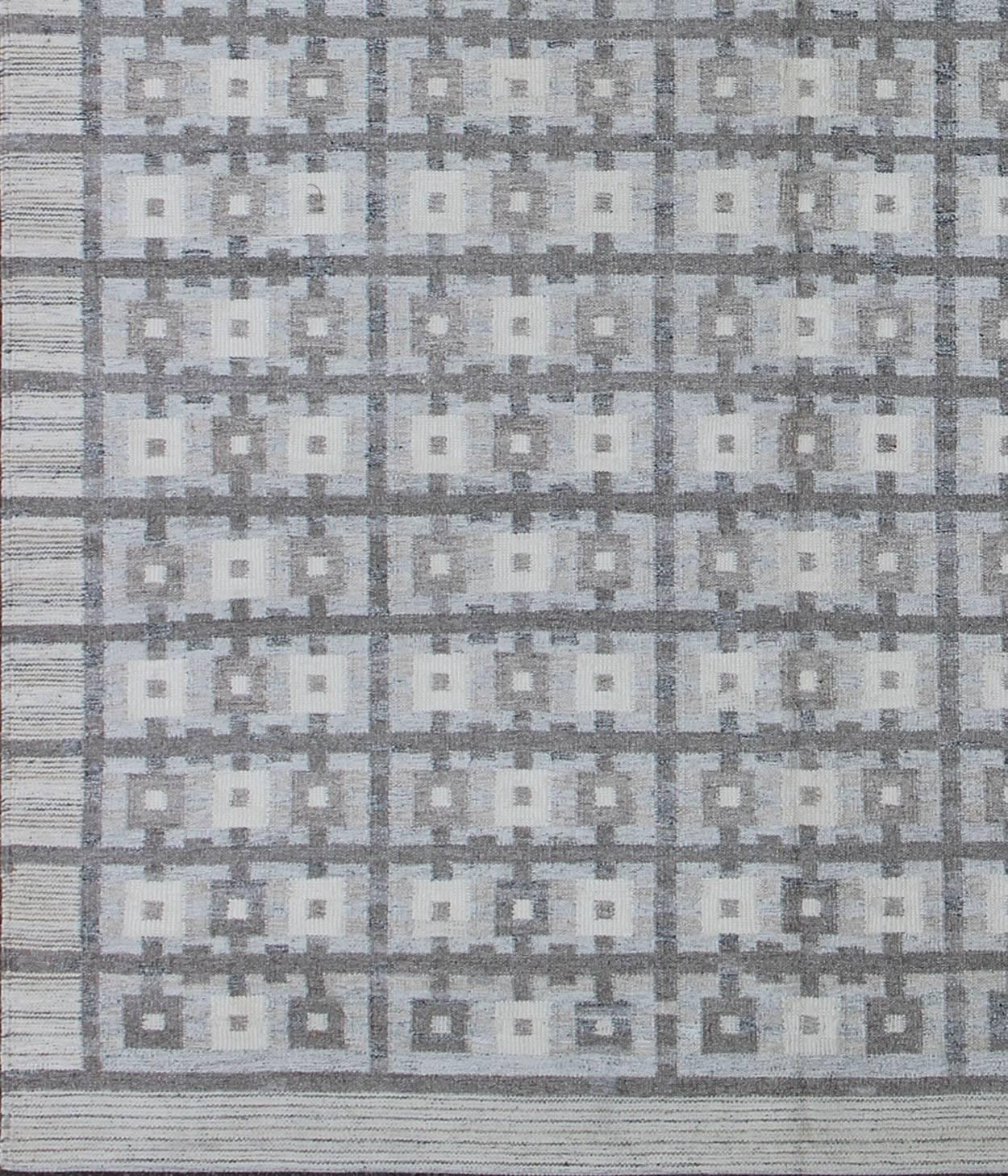 This Scandinavian flat-weave patterned rug is inspired by the work of Swedish textile designers of the early to mid-20th Century. With a unique blend of historical and modern design, this dynamic and exciting composition is beautifully suited for