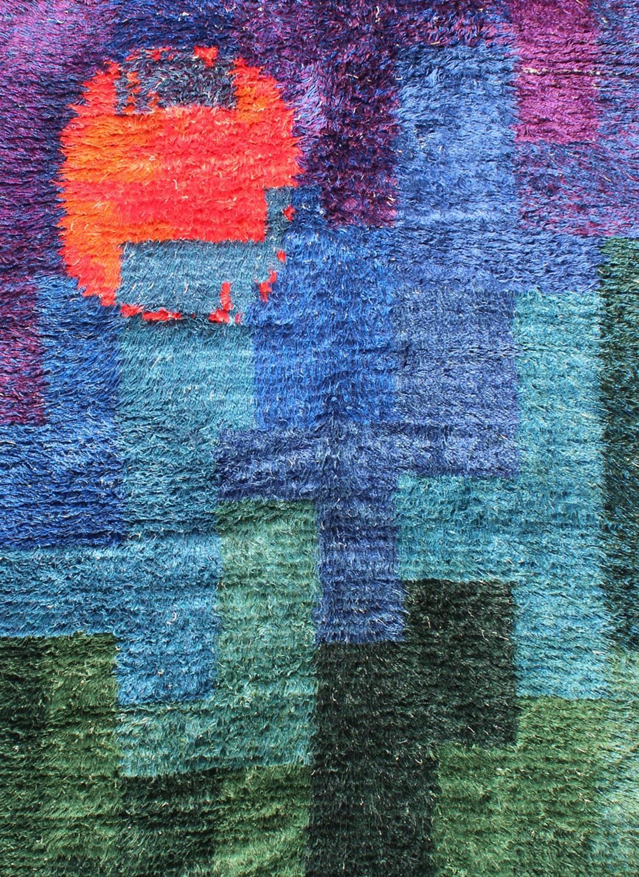 Measures: 4'10'' x 7'2''.
The richly opulent colors and unusual design of this Scandinavian carpet transport you to Mid-Century Europe. The unique abstract design and variety of vivid colors are cheerful and brilliant, making this piece a great fit