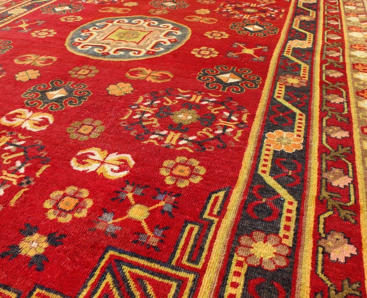 Antique Khotan Rug in Rich Red, Green and Charcoal Colors In Good Condition For Sale In Atlanta, GA