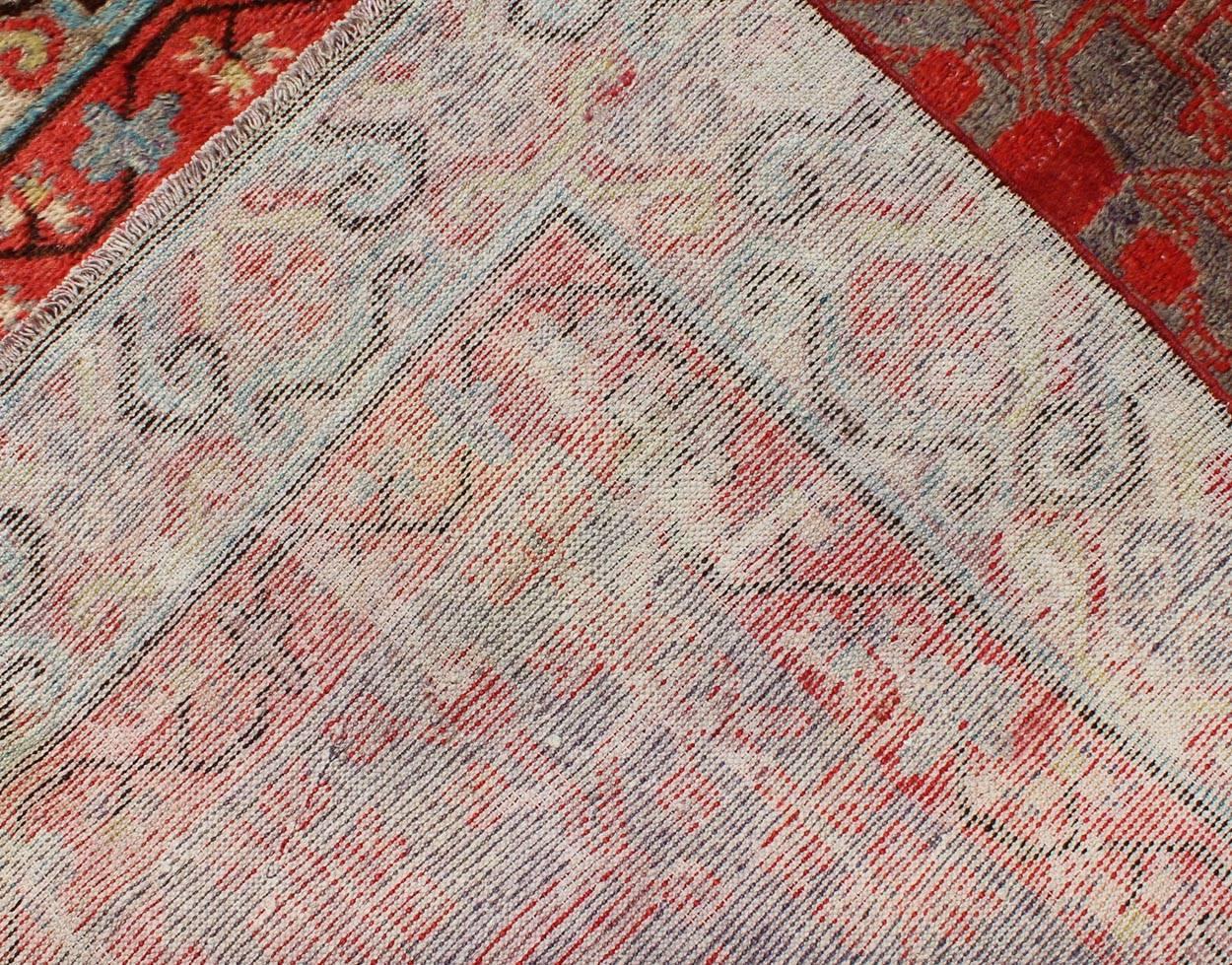 Early 20th Century Intricate Vintage Khotan Rug with Sub-Geometric Design in Reds and Light Blue For Sale