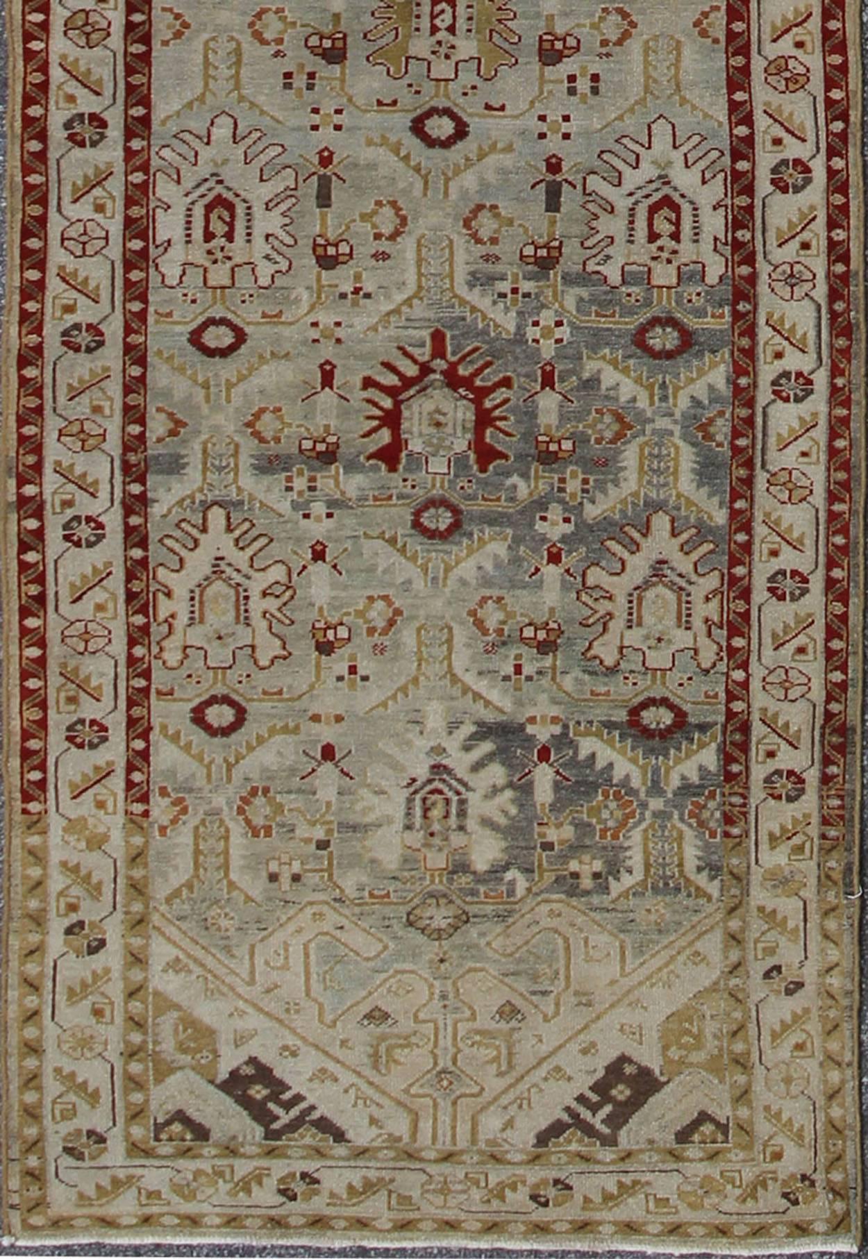 This magnificent antique Persian Malayer carpet, of an impressive pattern, bears a beautiful, all-over sub-geometric design paired with a delightful palette of reds, various blues and a very light green. The central field is filled with a dazzling