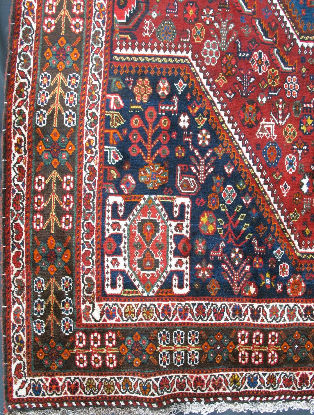 This multi-colored Persian rug features an all-over background and a central medallion with red, blue, brown , yellow, green and peach colors.
Measures: 5.7 x 8.