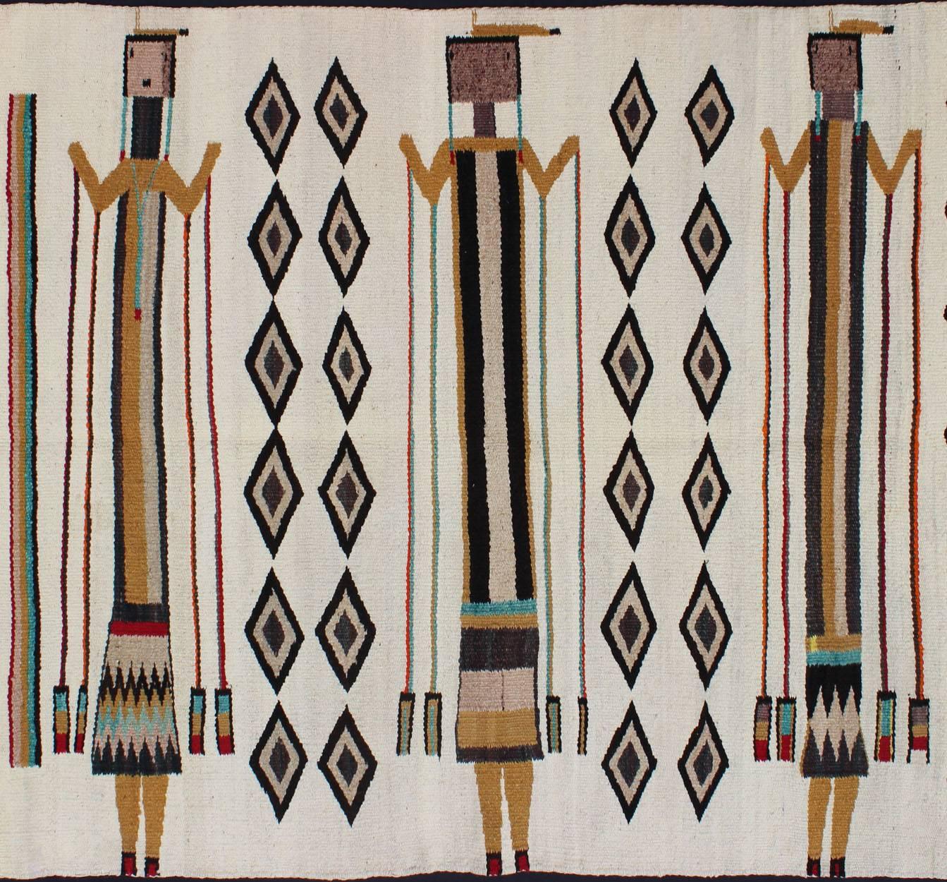 This Yei pictorial weaving features a unique composition and likely depicts a quadrant from a sand painting. Three figures with repeating diamond patterns between them are set on an ivory field.
Measures: 3'4 x 4'1.