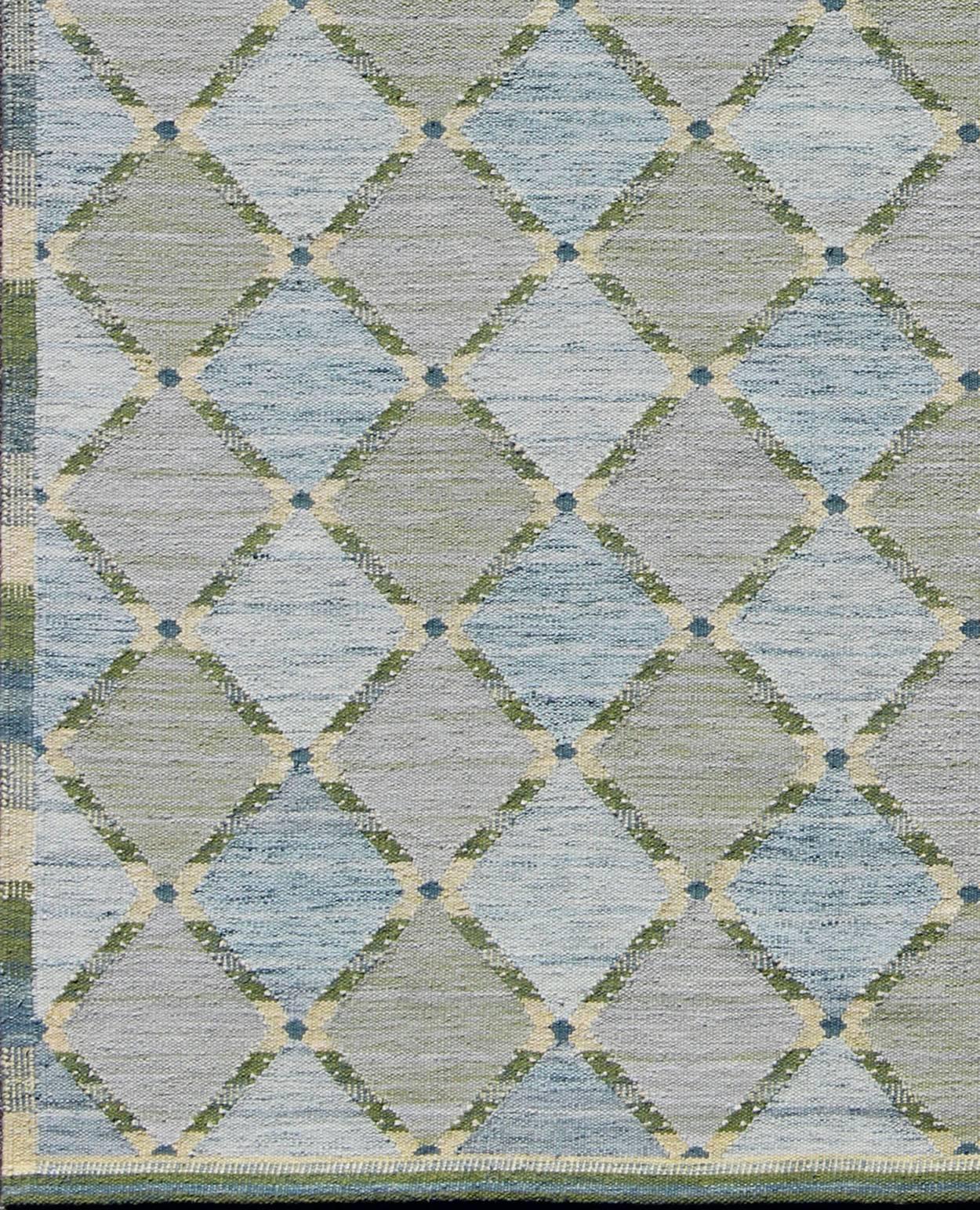 Measures: 9'5'' x 11'5''.
This Scandinavian flat-weave patterned rug is inspired by the work of Swedish textile designers of the early to mid-20th century. With a unique blend of historical and modern design, this dynamic and exciting composition is