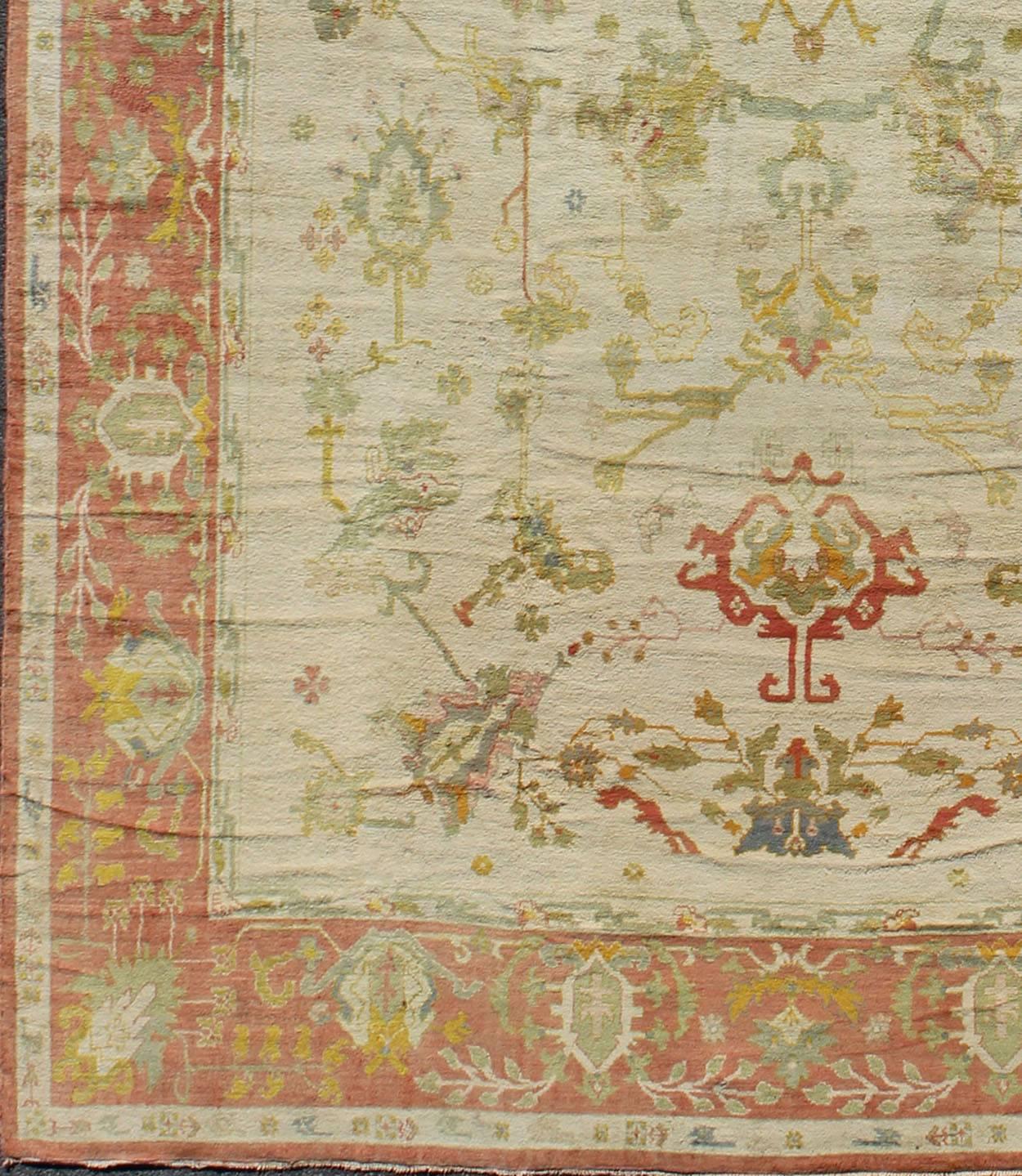 Antique Spanish large rug in ivory background, green and coral border, rug / 16-0923, This magnificent Spanish carpet from the mid-20th century, with its stunning array of colors, is characterized by a design of elegant beauty. The colorful patterns