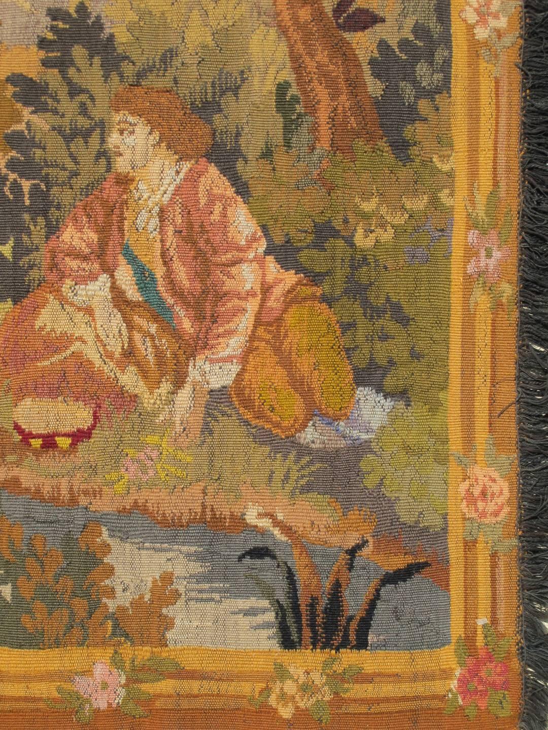 This engaging antique French Tapestry depicts a traditional woodland landscape. The entire scene is set within an abundant woodland setting of trees, bushes and various flora. The weaver’s artistry is further exemplified by the use of a strong and