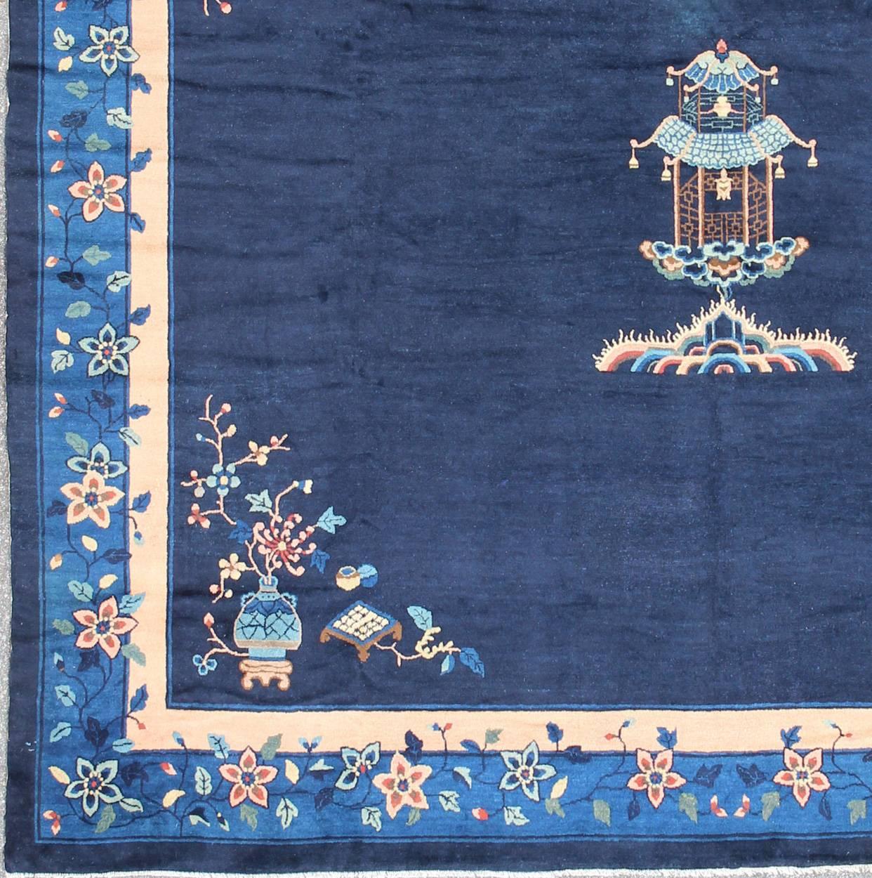 Alive with color and exotic patterns, this beautiful antique Chinese rug features a traditional Chinese design in blue and sapphire tones. Handwoven in China in the early 20th century, this distinctive piece showcases a sophisticated pattern