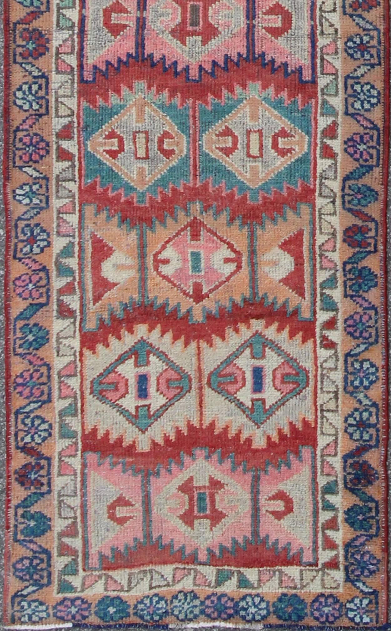 Unique and Colorful Turkish Oushak Runner with Intricate Geometric Pattern
This Turkish Oushak runner features repeating geometric motifs of varying size, shape, and color. The two borders are an extension of this colorful geometric theme. Colors