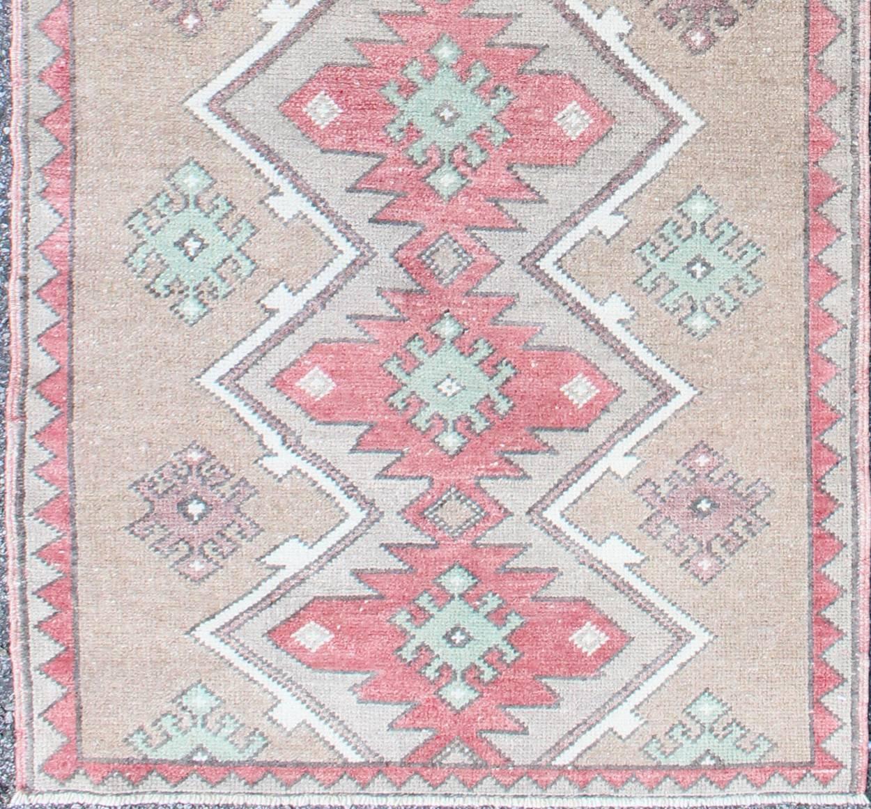Turkish Tulu Runner With Geometric Medallions in Vivid Coral, Tan, and Mint Green. Rug EN-142686. Keivan Woven Arts country of origin / type: Turkey / Tulu circa mid-20th century.

This Tulu runner contains seven red and light green medallions laid